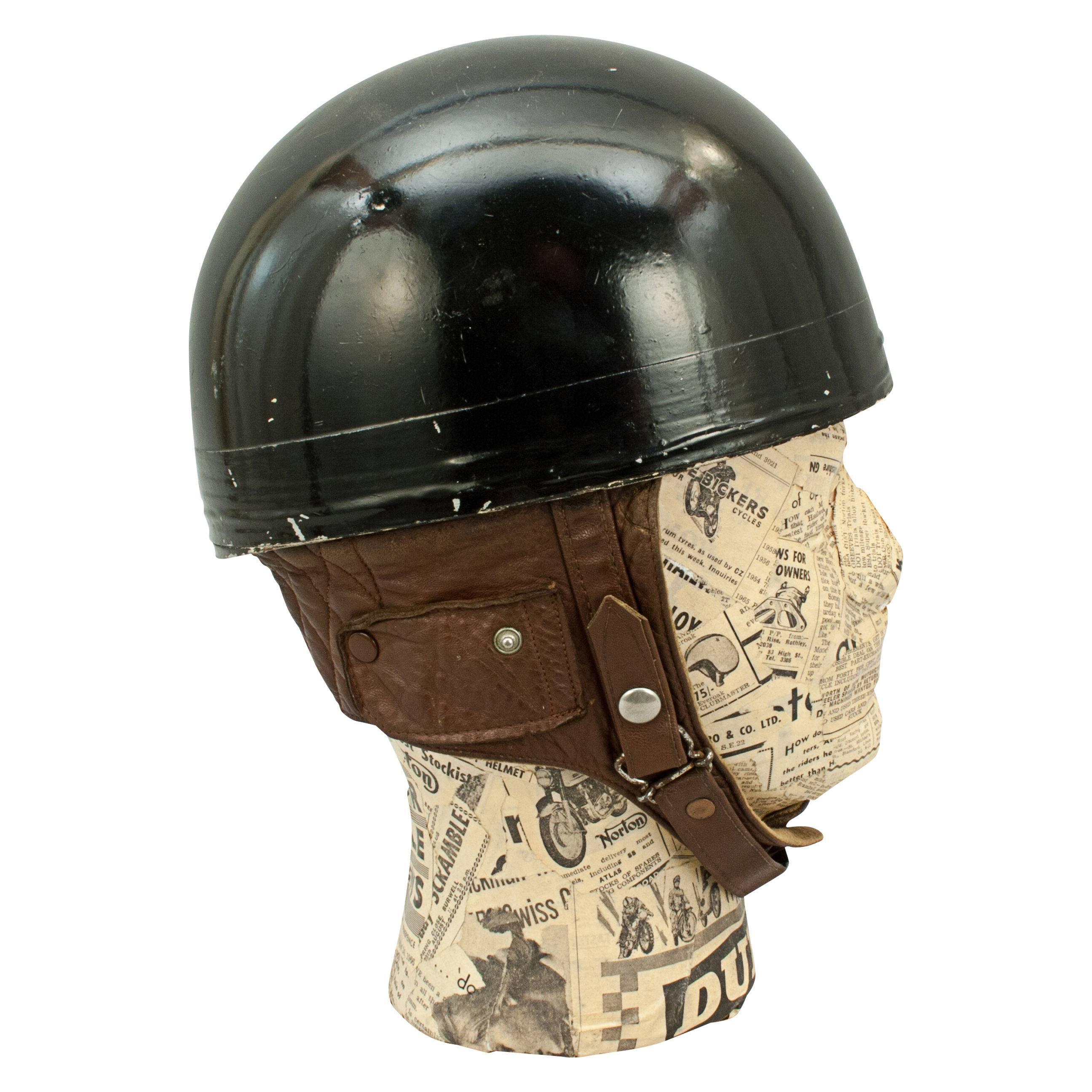 Vintage A.C.U. Motorcycle racing crash helmet, Everoak.
A fine black painted motorcycle, pudding basin shape helmet made in England by Everoak. This helmet has a cork interior, fitted with a leather headband and straps keeping a space between the