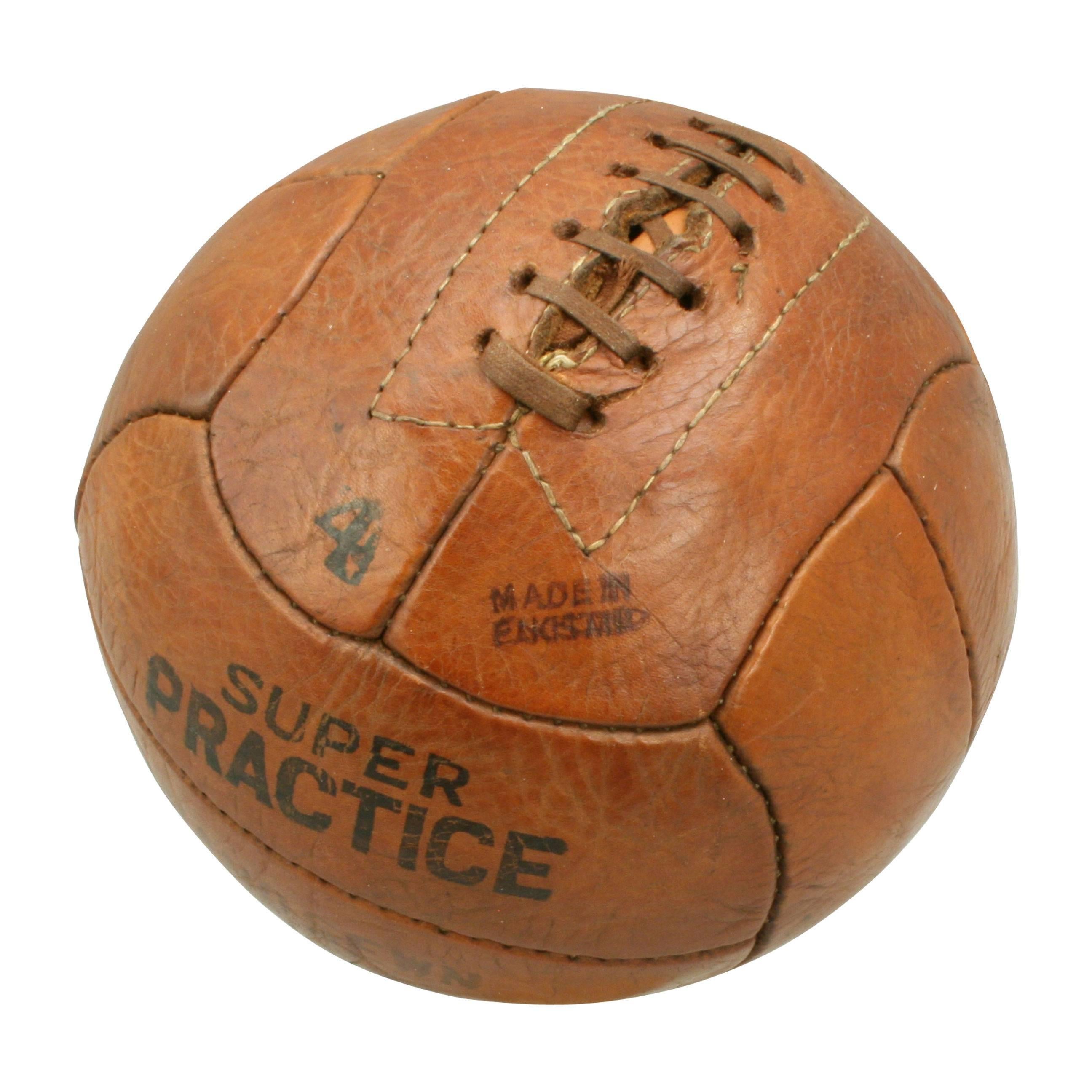 Vintage no.4 leather football.
A traditional hand-sewn 12-panel tan leather football in very good original condition. The ball has a lace-up slit to the top to enable bladder inflation. Ball is marked '4, super practice, hand-sewn, made in England,