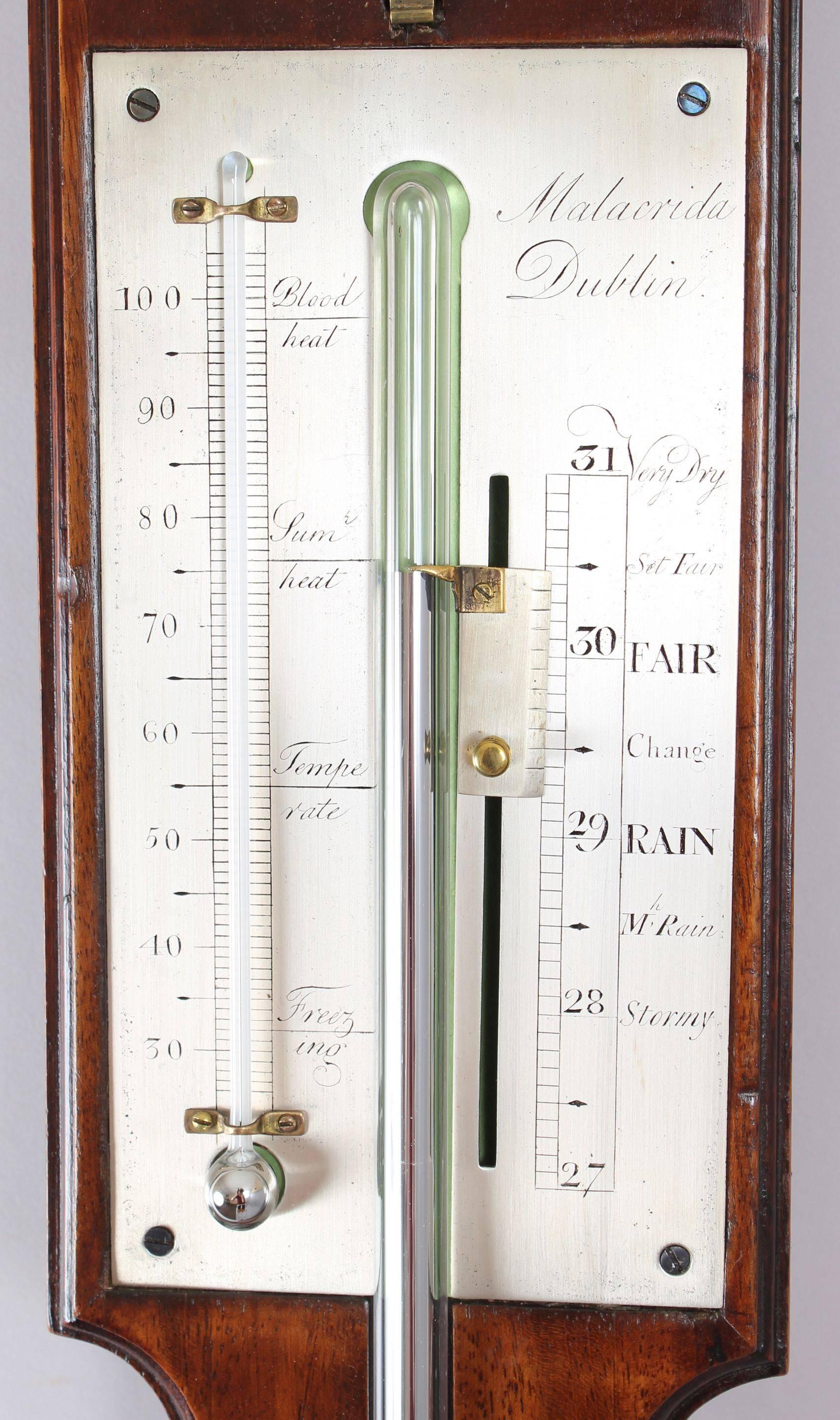 Early 19th century mahogany stick barometer by Malacrida of Dublin*; the finely engraved silvered register panel with vernier scale with mercury thermometer and hygrometer; on a mahogany case with moulded edge surmounted by a broken arch pediment.