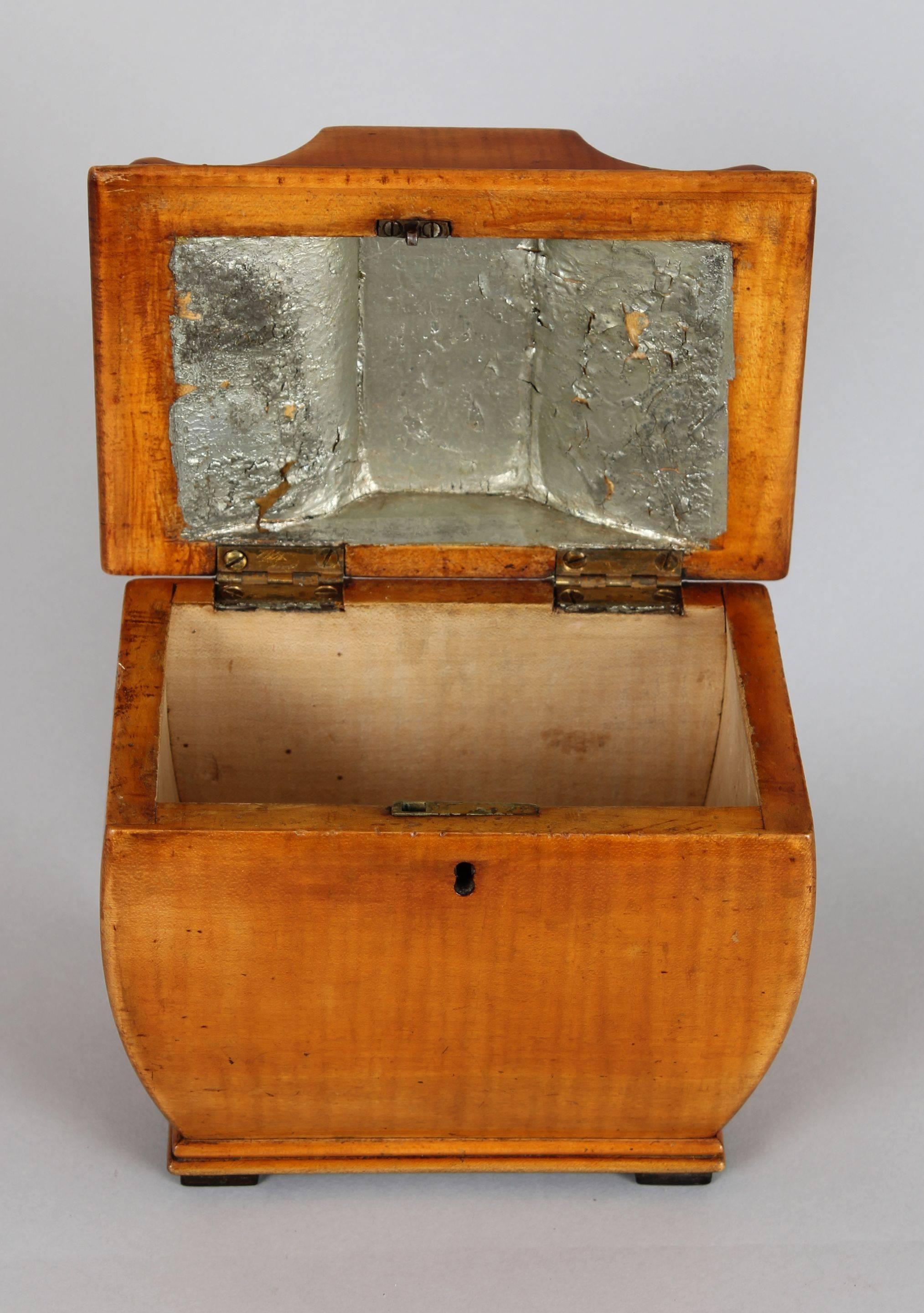 19th century Biedermeier tea-caddy of shield profile in stripy-grained birch.