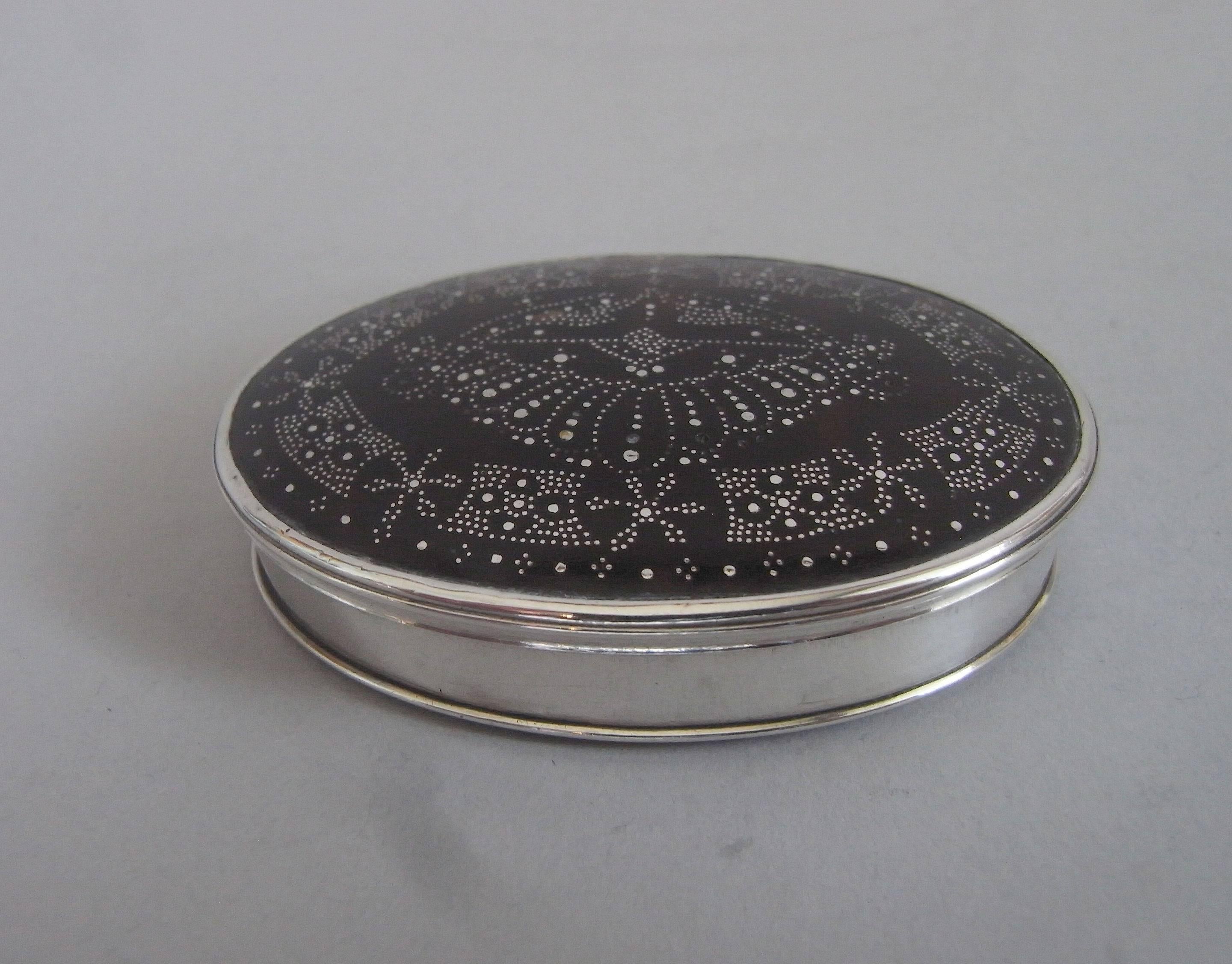 The snuff box is of a most unusual size and was most probably for the use of a Lady. This example is oval in form, with silver sides and hinge. The tortoiseshell base and cover are secured in place by a silver oval frame. The base displays a plain