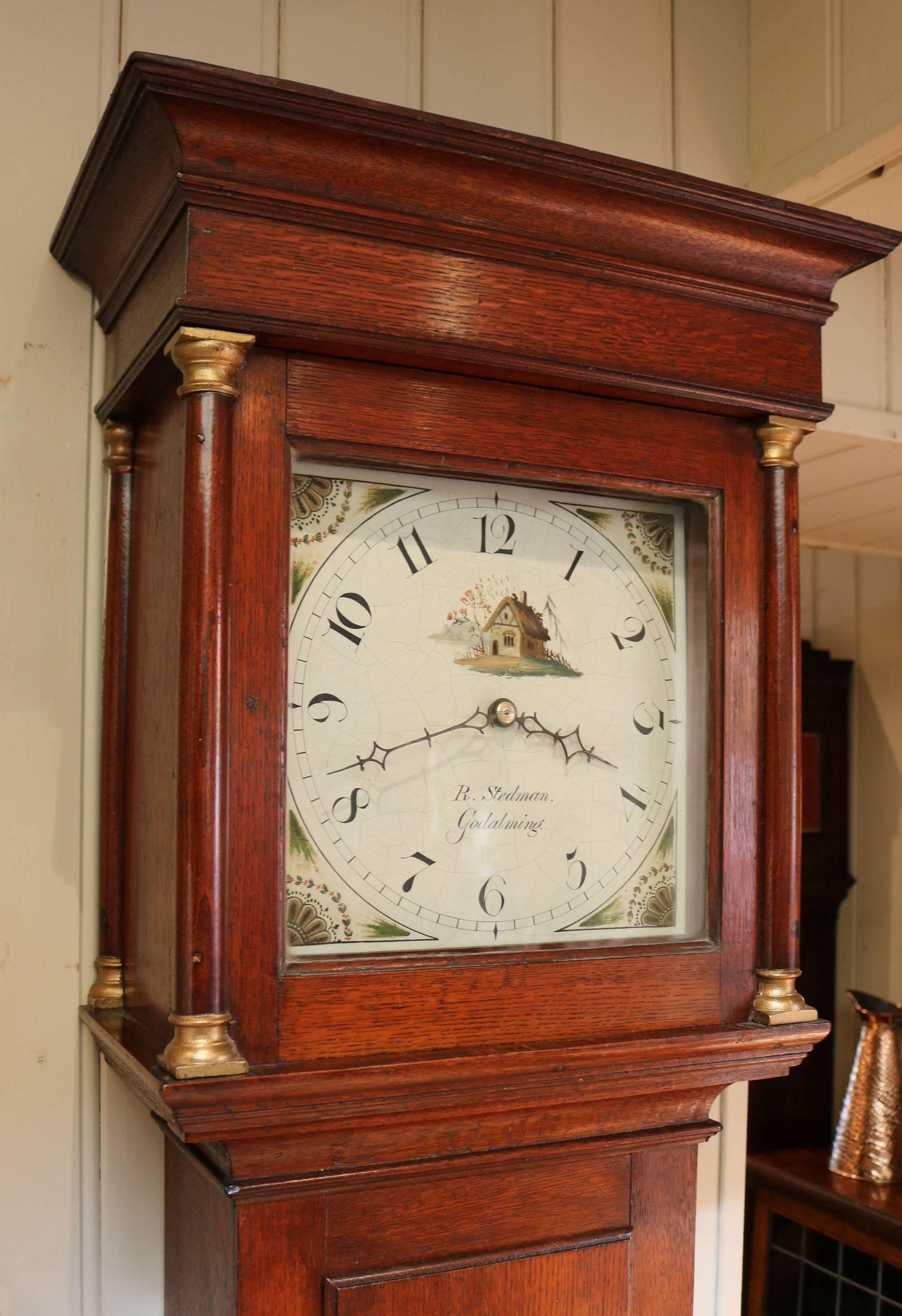 An nice original solid oak country longcase clock of simple form. It has a flat top, hood side pillars and a long door. The 11