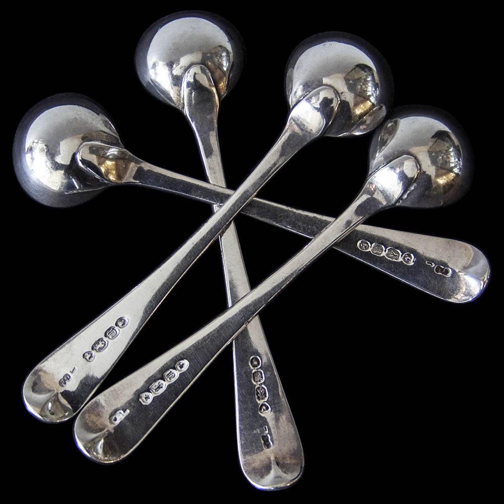 A good set of four single struck Bead pattern salt spoons with original gilding in the bowls and each engraved with the initial B.