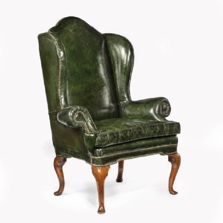 Re-upholstered in distressed green leather, English, circa 1720.
Measures:
H 51 ½ in W 37 ½ in D25 in 
Seat depth 20 in width 28 in.
