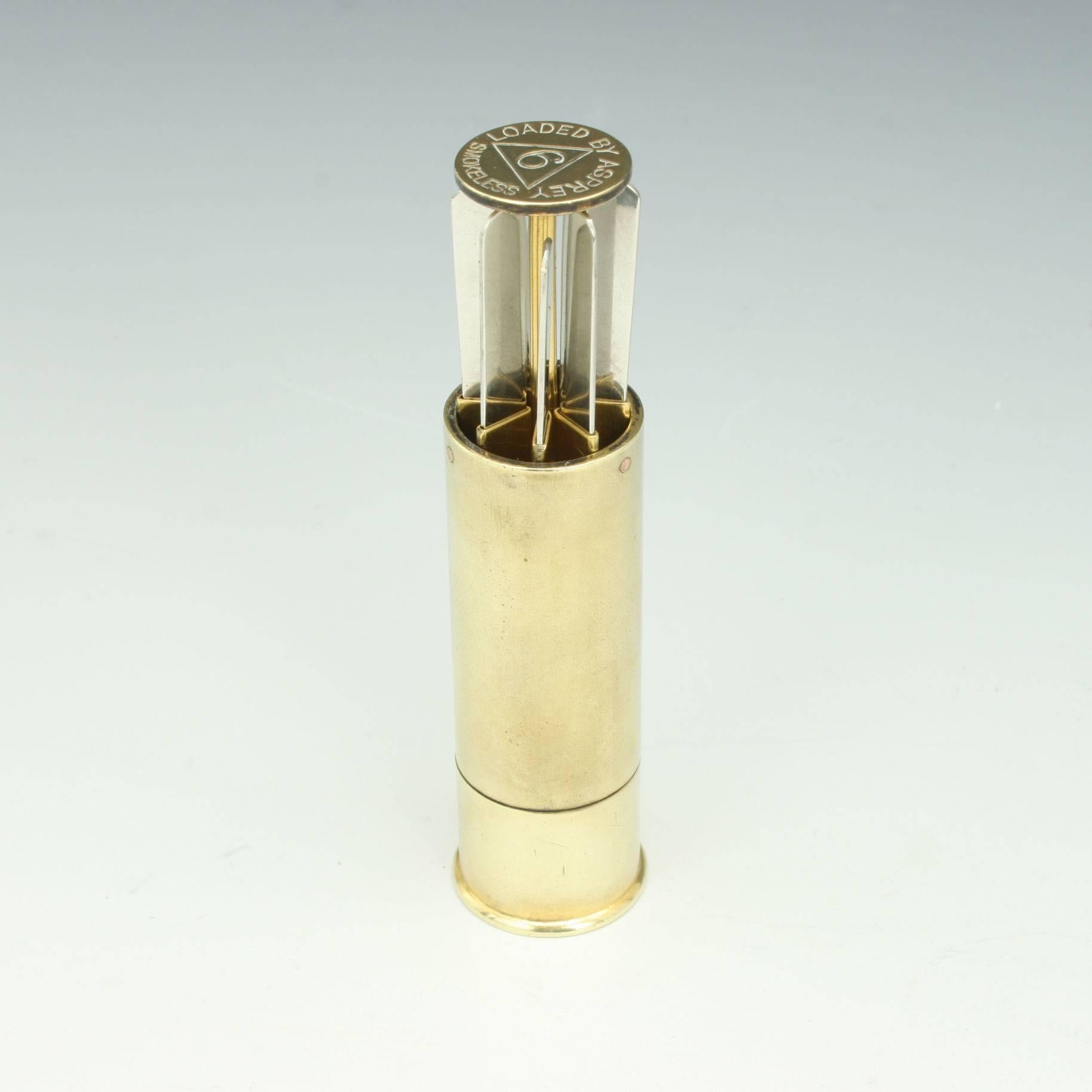Vintage Asprey's cartridge placefinder 
A well crafted and engineered 1930s shooting place finder or butt marker in the shape of a 12 bore shotgun cartridge. The cartridge is made of brass/gun metal by Asprey of London. When twisting the cartridge