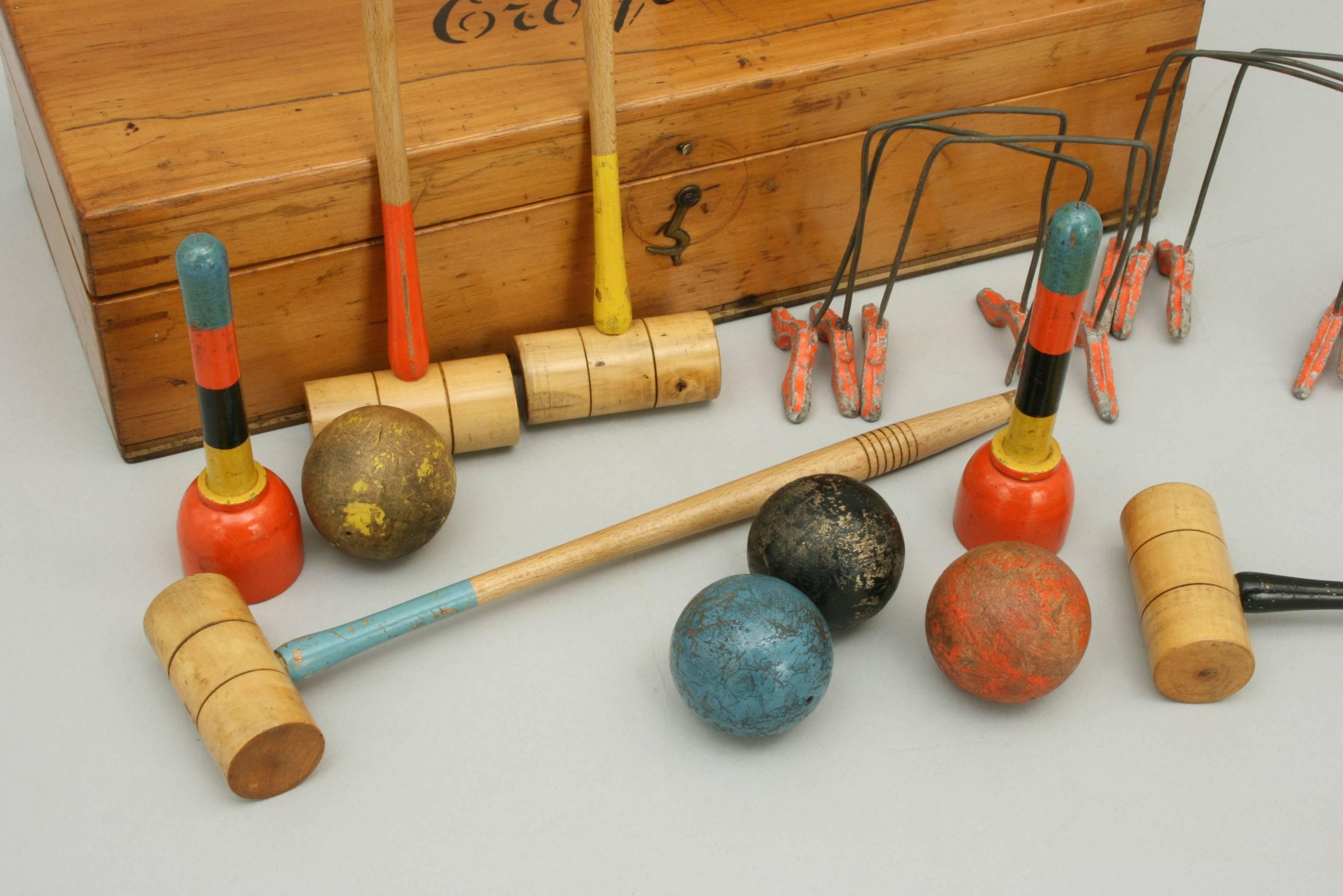 This miniature table croquet set is similar in every way to a full sized set but made for use on either a dining or billiard table. The mallet heads are made of boxwood and the full length of each mallet is 9 ½ inches. The game comprises of four