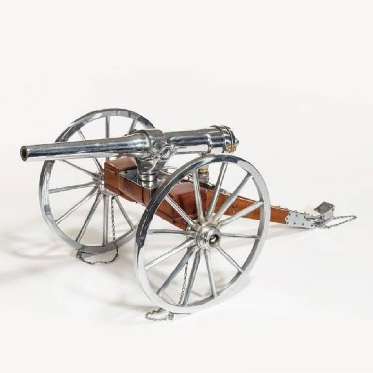 A fine mahogany and nickel-plated scaled model of a British Artillery field Cannon by Whatley Kirk and Co. 

circa 1899