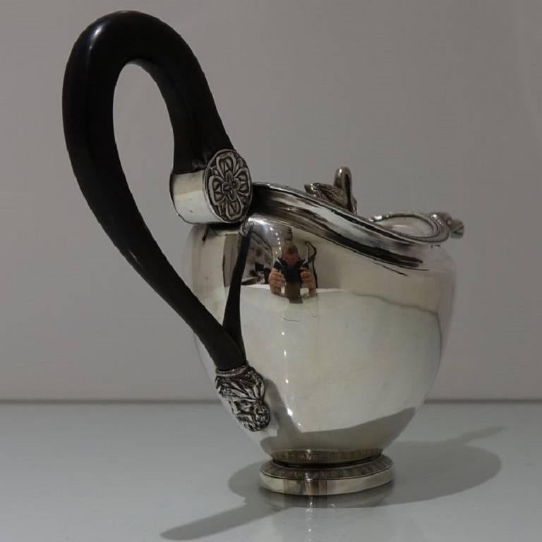 A very fine and extremely collectable European made silver teapot with plain formed tapering body. The teapot sits on a oval foot with a elegantly engraved outer band for lowlights. The spout is stylishly constructed and the hinged lid is crowned