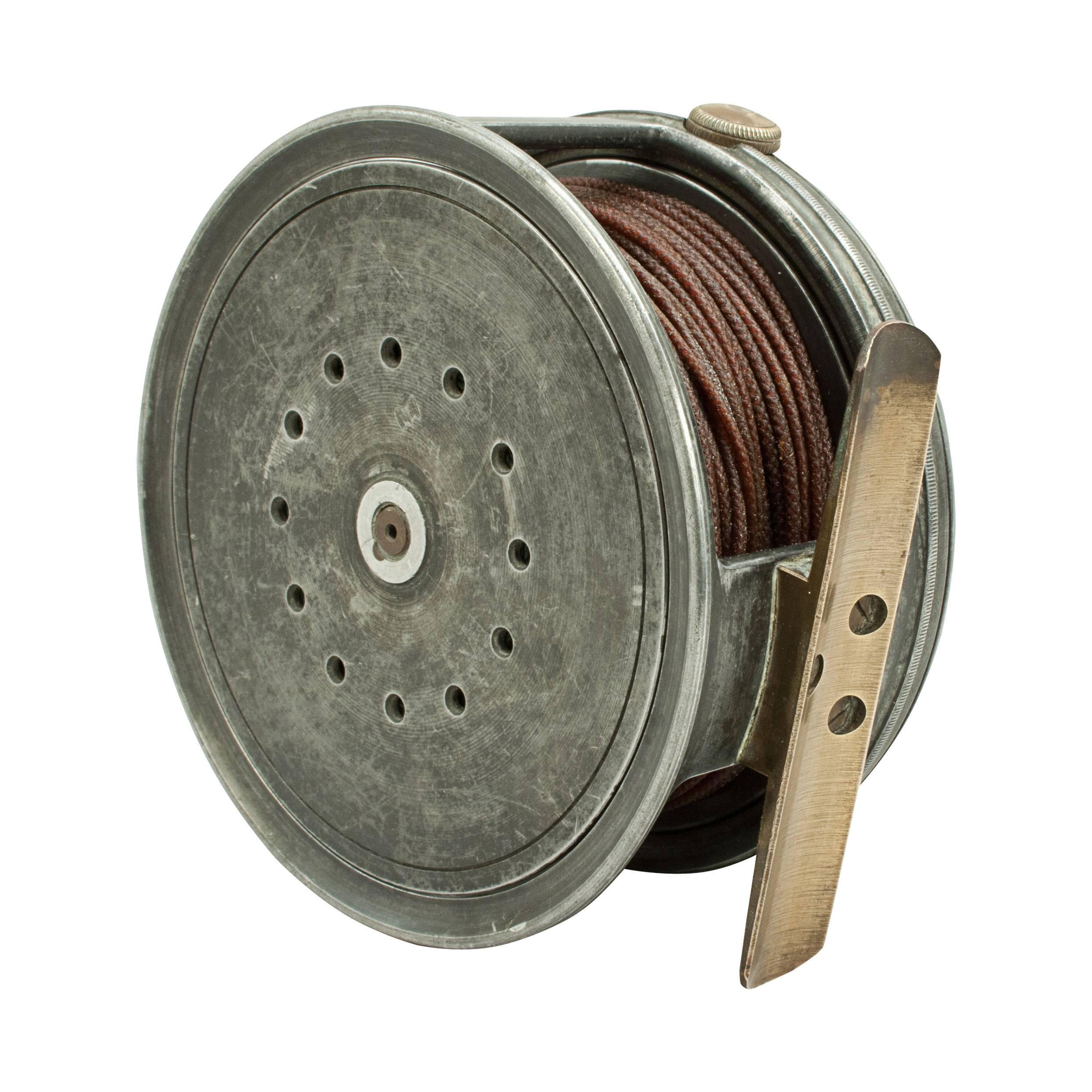 Salmon fly fishing reel by Foster of Ashbourne. This is a 'Hardy Perfect' type salmon reel made from aluminium with bakelite handle, brass foot and tension screw. The reel comes with silk line.
