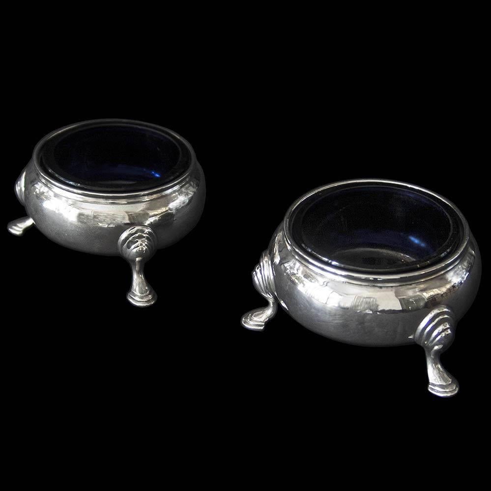 A good pair of Victorian silver plain, compressed circular salt cellars on three hoof feet.