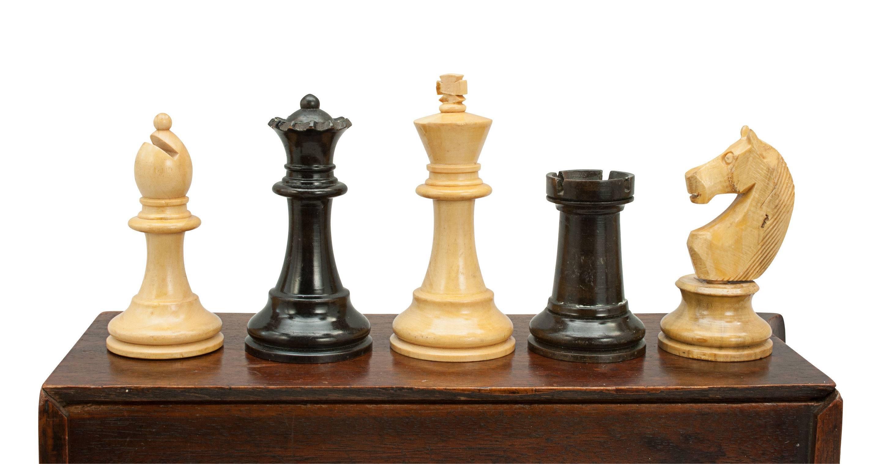 A well turned chess set in mahogany box with sliding lid. The set has boxwood and ebonized figures. The King is 3 inches high and the pawns are 1 6/8 inch high. It is in very good condition with no damage to the pieces.