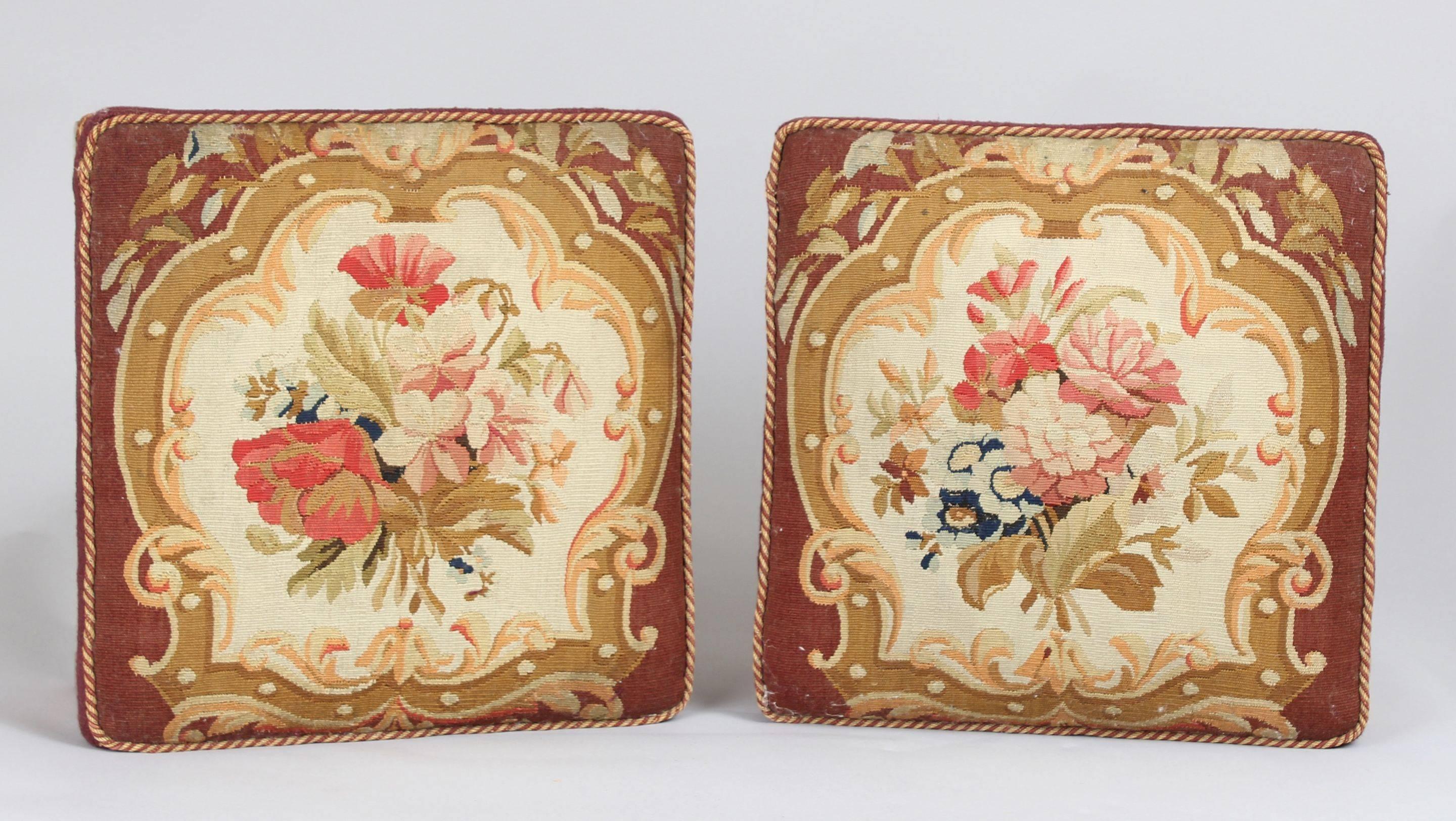 Pair of late George III period satin-birch foot-stools probably made to take the earlier panels of Fine petit-point floral needlepoint which have been conserved and reinstated with their old gimp and braid on the re-upholstered frames.