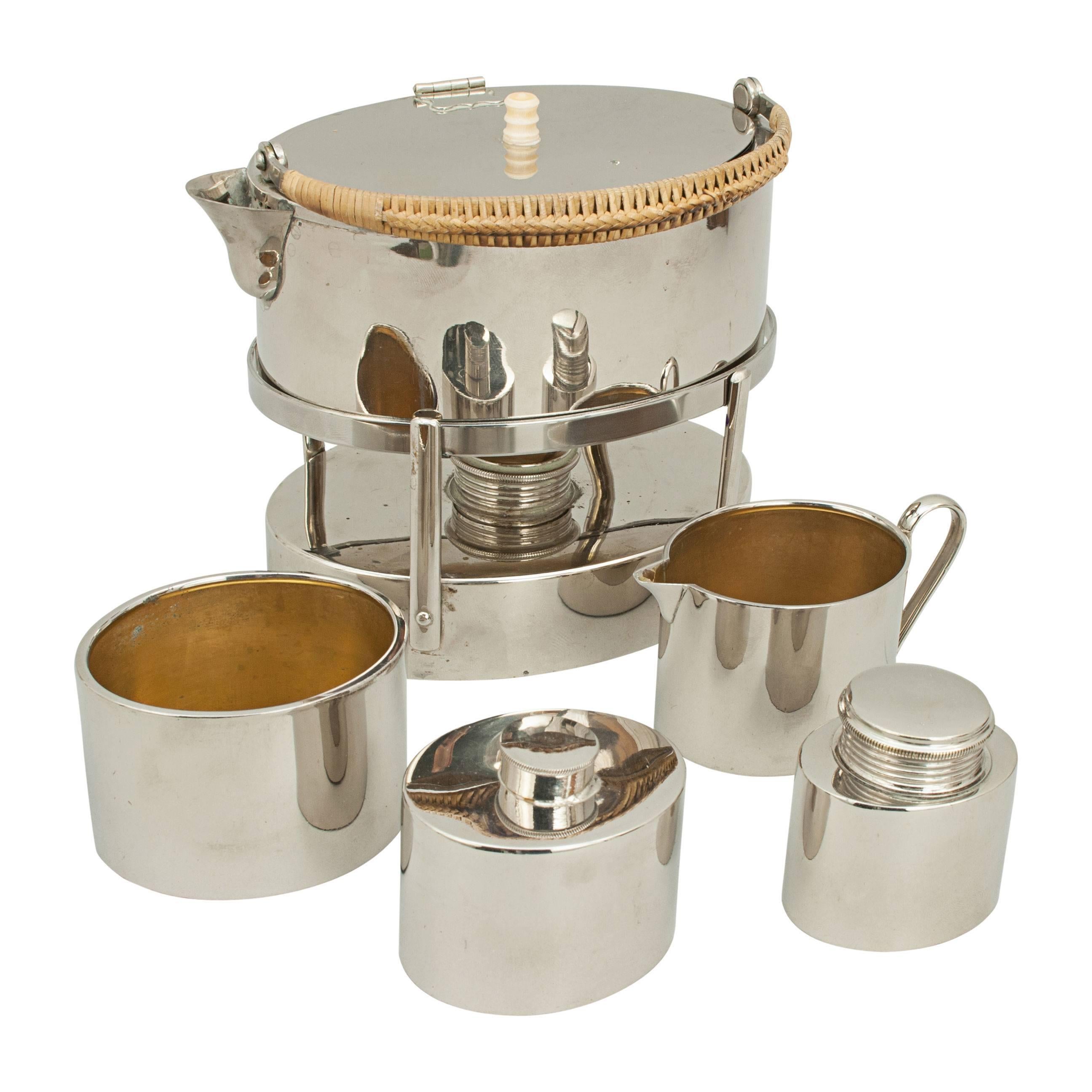 Campaign picnic set, tea maker. 
A late Victorian chrome-plated metal traveller's tea set in original leather case. The set comprising of a kettle that doubles as a tea pot, a spirit burner, jug, an oval bowl and two containers with screw lids.