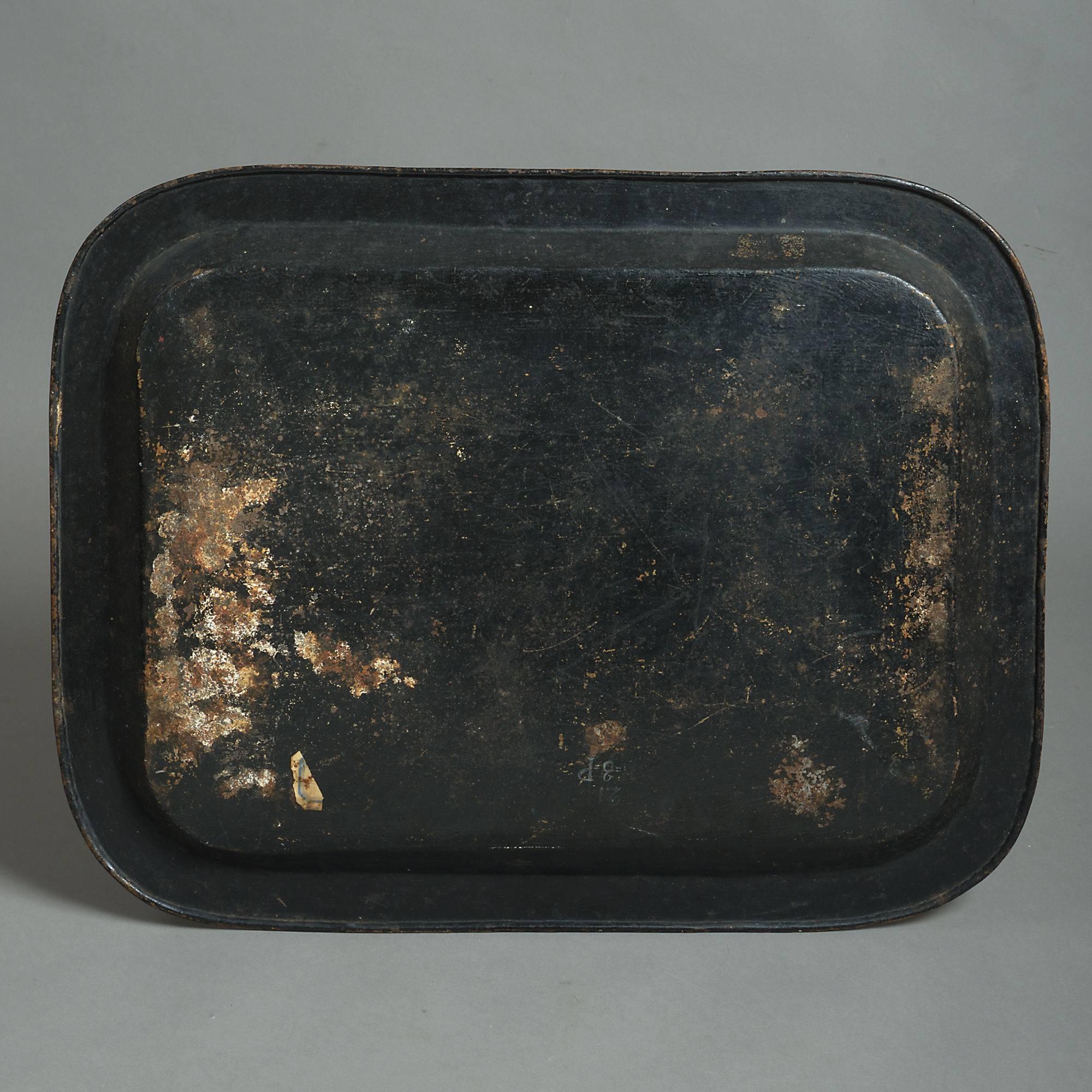 An early 19th century rectangular tole tray, the surface decorated with gilded chinoiserie upon a black ground.