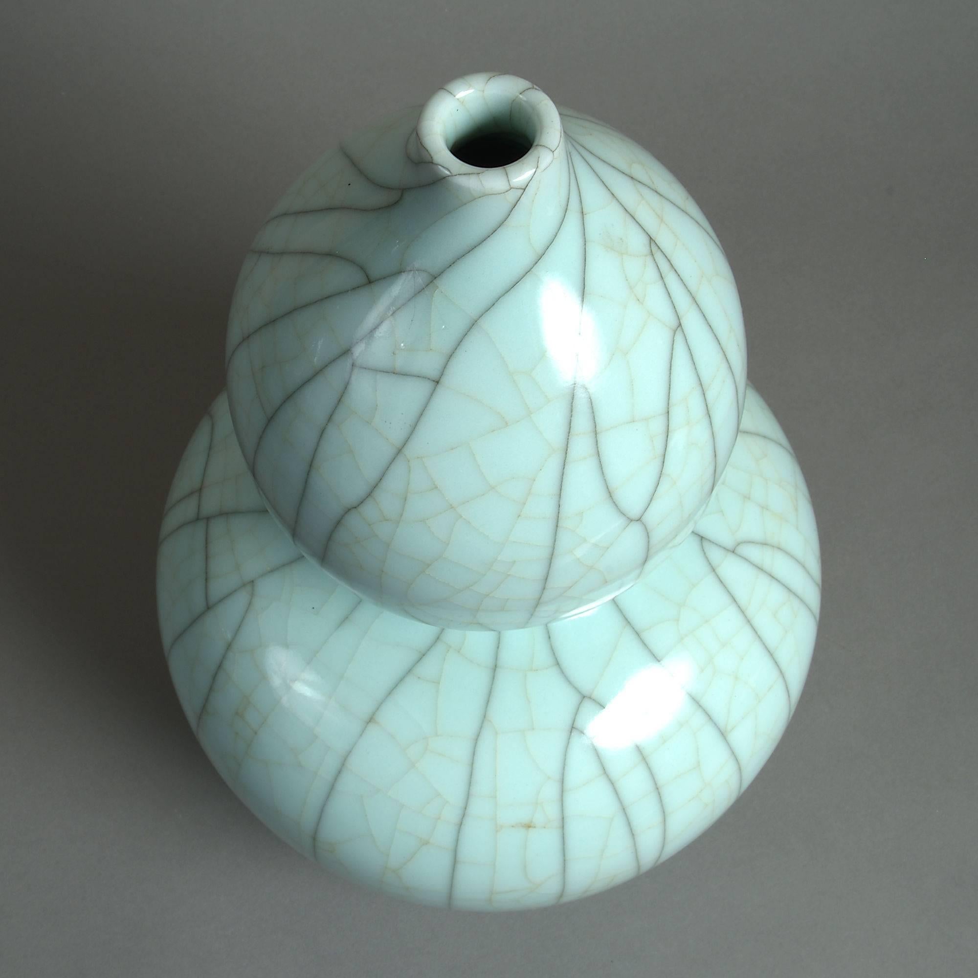 A 19th century celadon crackle glazed porcelain gourd vase of good scale. 

This vase employs a delightfully pale shade of celadon glaze. The cracquelle surface is especially pleasing as it exists in two shades: jet black lines over much faint and
