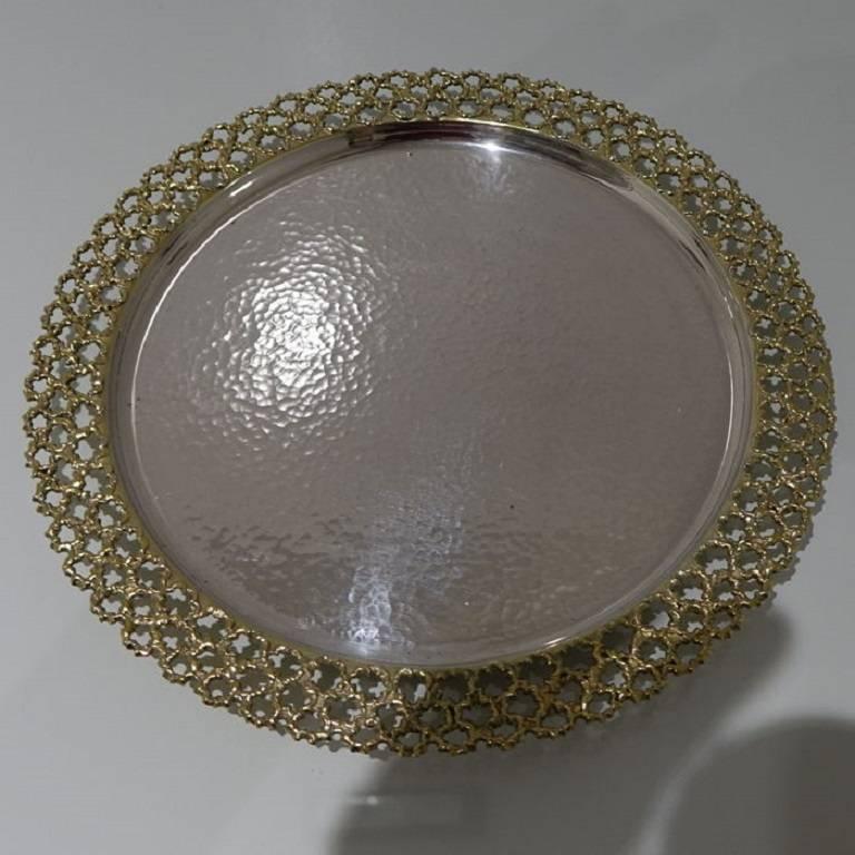 A highly collectable silver salver with a stylish hammered finished to the body and decorative pierced gilt border for contrast. The salver is hallmarked on the underside of the base.
