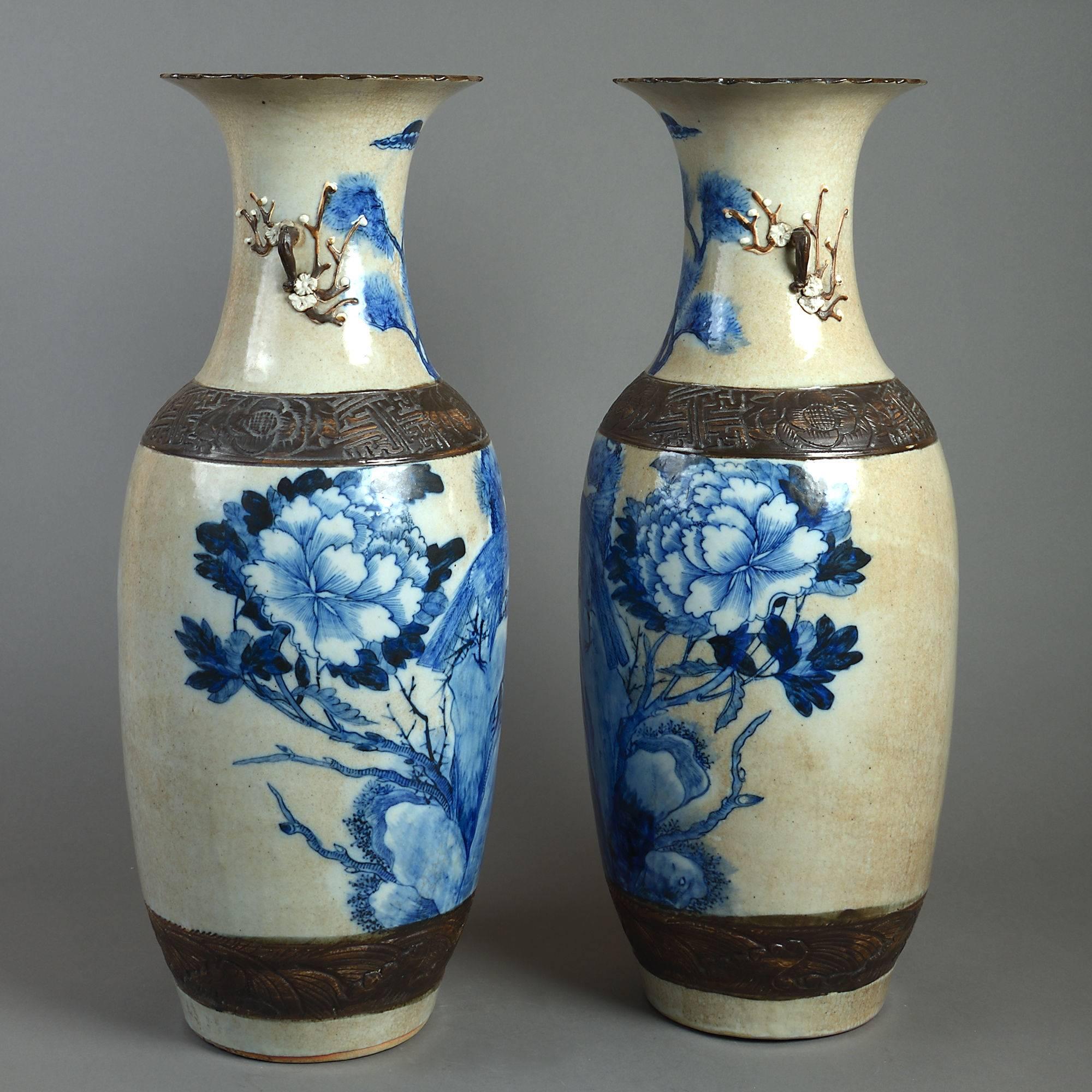 A good large-scale pair of late 19th century Qing dynasty porcelain vases, the cafe au lait crackle glazed bodies with blue glazed decoration of mythological beasts, birds, rocks, flowers and foliage.