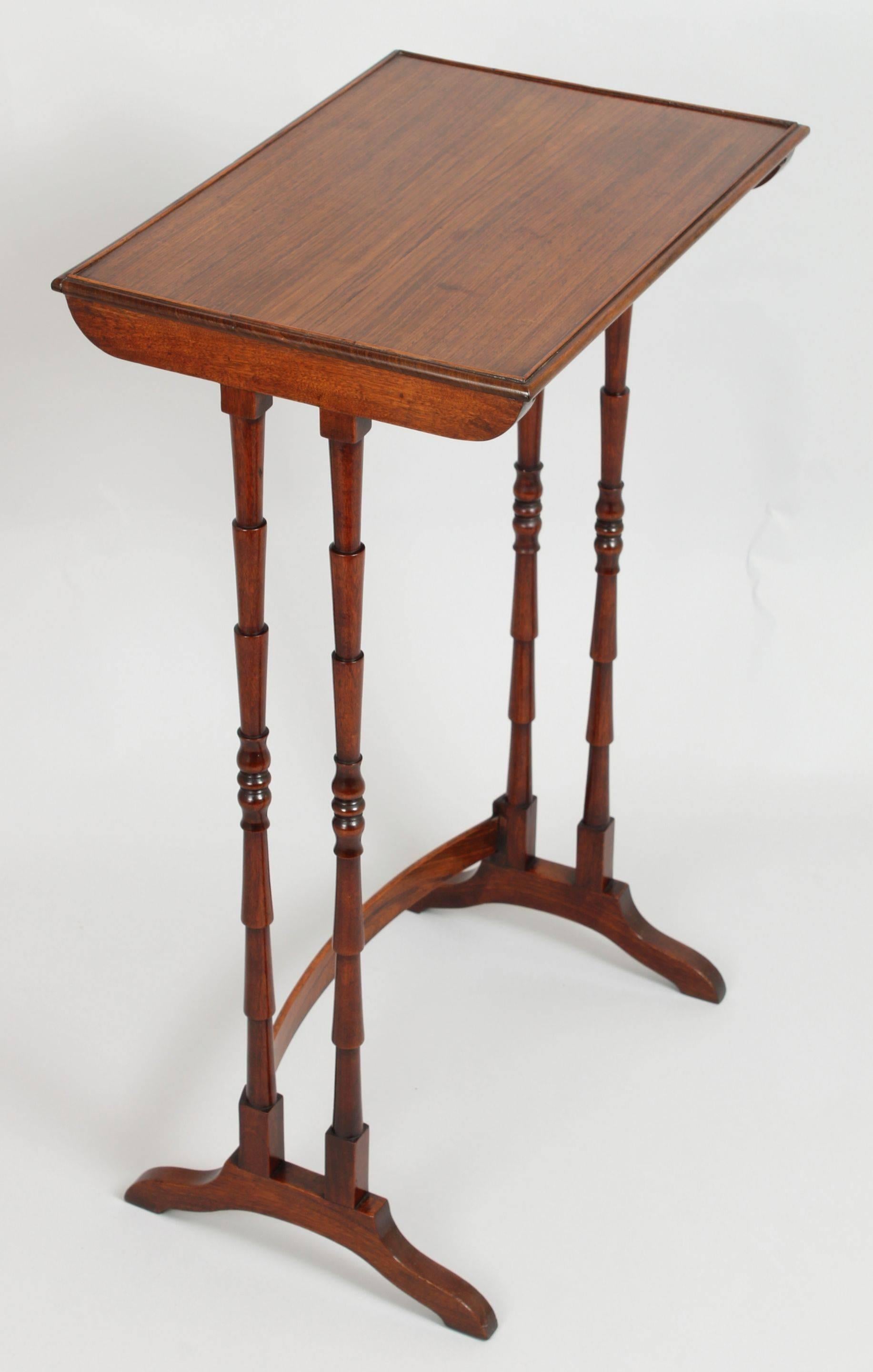 Nest of three tables in rosewood; the nicely grained tops with an inset beading, standing on ‘bamboo’ legs on to splay feet, with curved stretchers.,
circa 1815.
