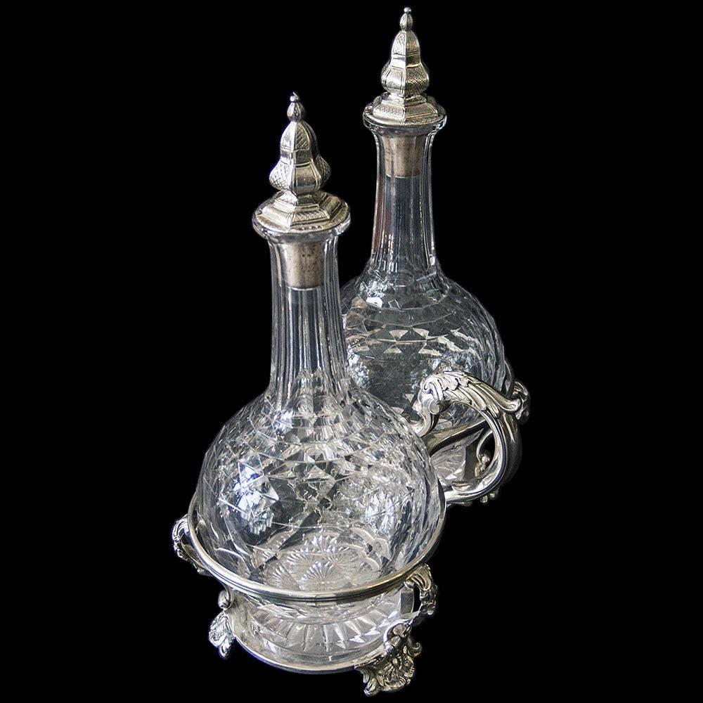 Robert Garrard. A very large and important fine quality oil and vinegar cruet comprised of two large cut-glass crystal bottles with * original * sterling solid hallmarked silver mounted cork stoppers in a rococo style frame with, cast floral