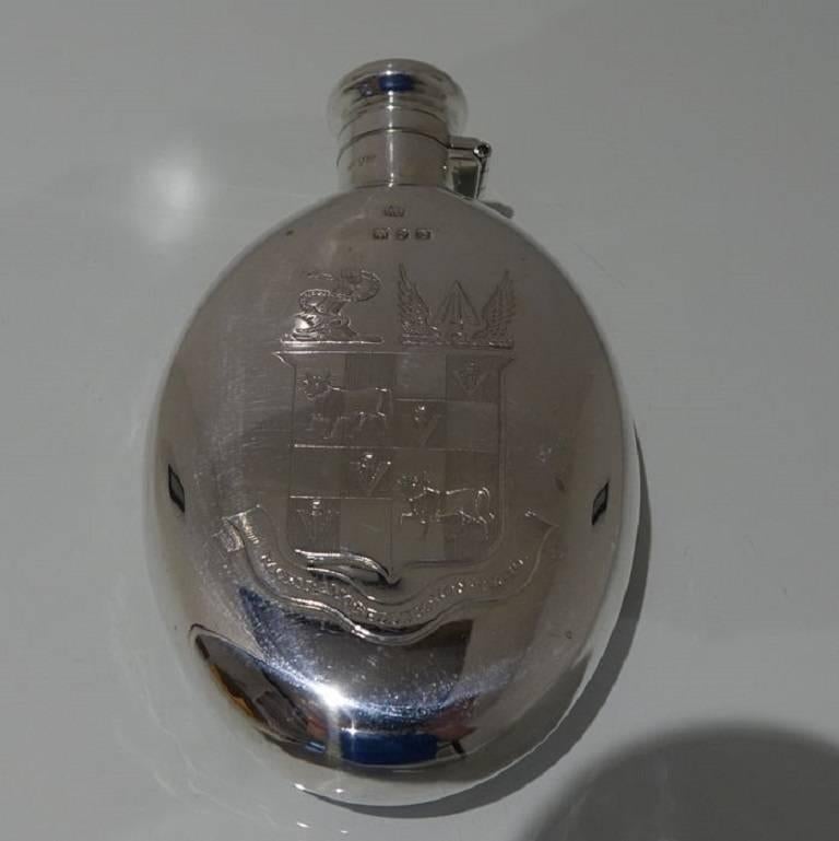 A very elegant and highly collectable 19th century silver hip flask plain formed in design with bayonet action clasp lid. The flask has an elegant contemporary armorial for importance.