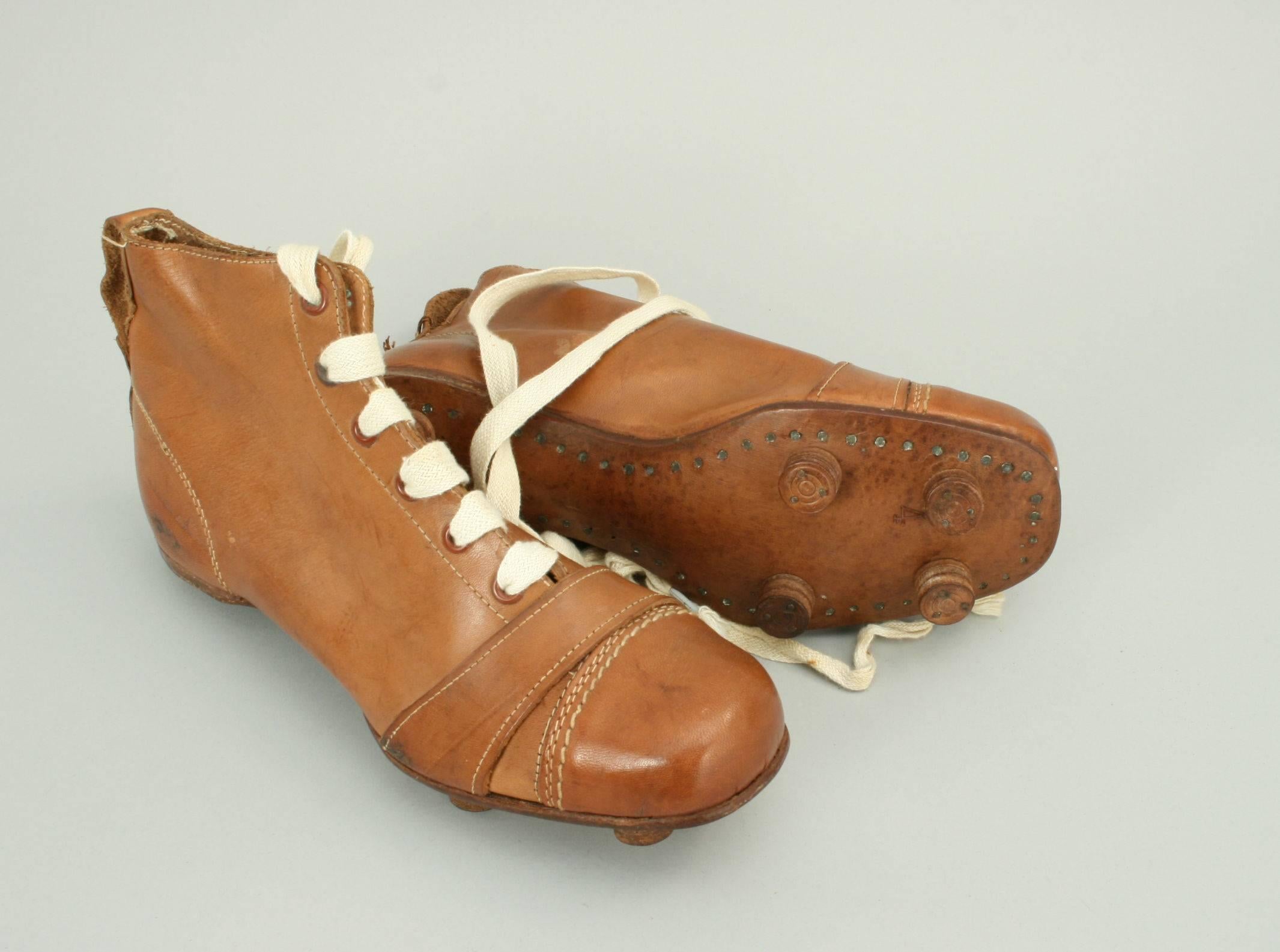 Vintage pair of leather football, rugby boots.
A pair of unused tan leather boots in exceptional condition. The toe area on the boots are made of hardened leather, as it was the normal play to toe-kick the football rather than use the instep as in