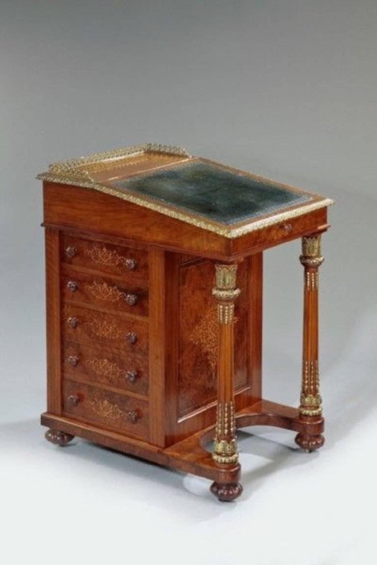 A fine quality Victorian walnut Davenport desk, incorporating candle slides, a pen tray, a satinwood interior and decorated with fine inlaid boxwood traceries and ormolu mounts.