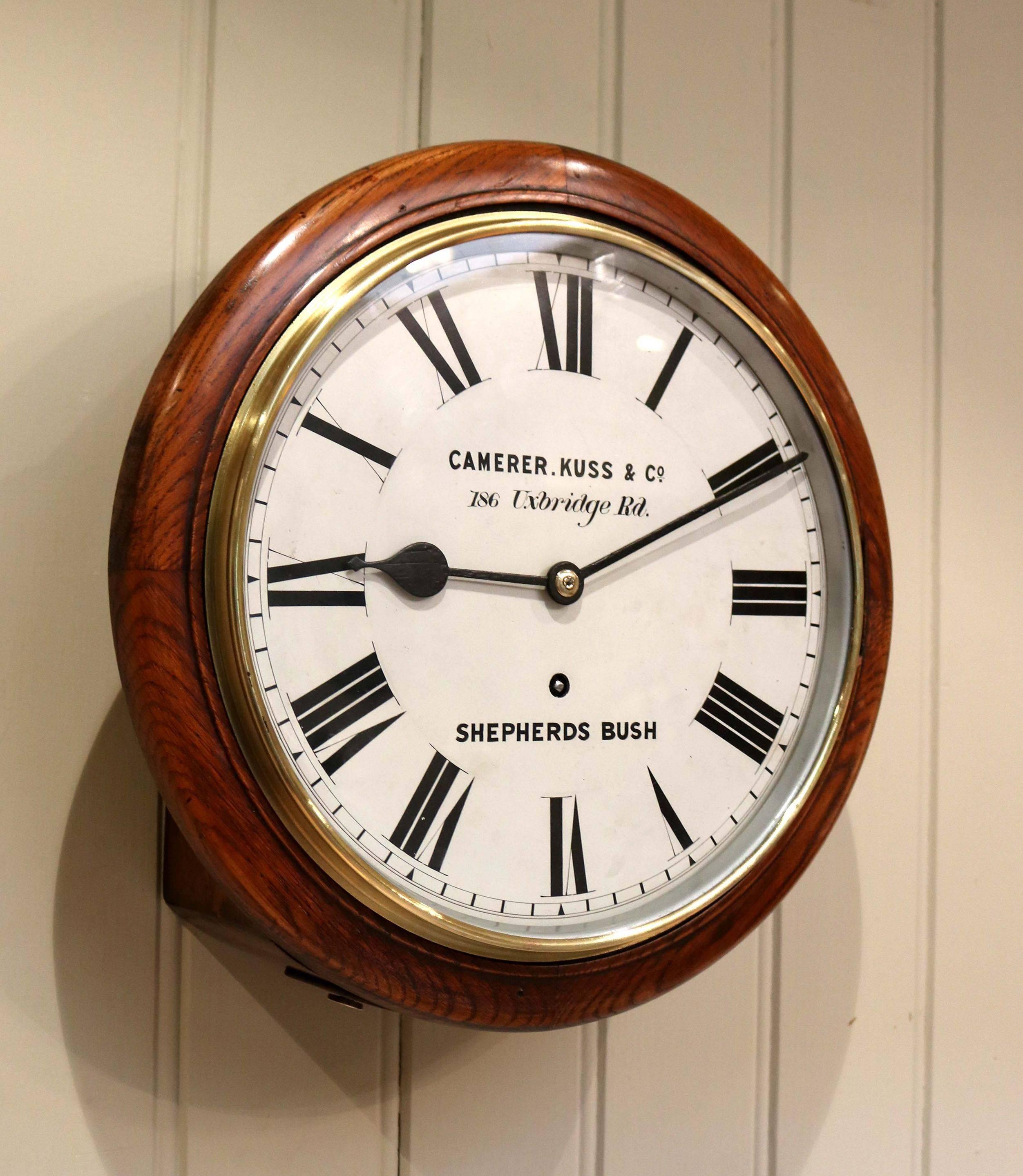 Late 19th century dial clock. It has a solid oak case the white painted dial is signed by the retailers Camerer Kuss of Shepherds Bush and has a polished and lacquered brass bezel. It has 8 day spring pendulum movement. Measure: 12”.
The