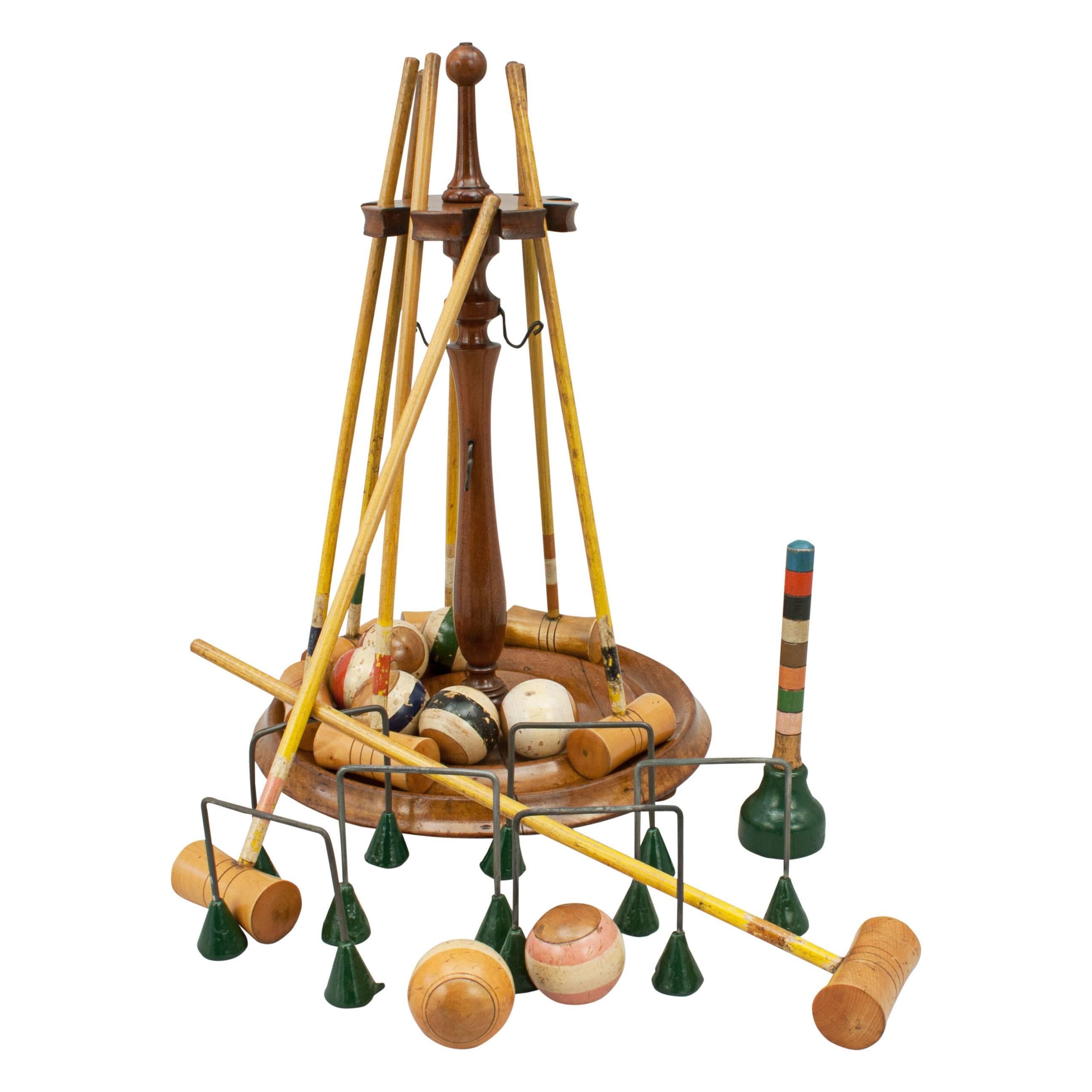 Tabletop Miniature croquet set. 
An original parlour game of miniature croquet. The tabletop croquet set comes on its original turned mahogany stand and contains 8 mallets and balls all made of boxwood. To complete the set there are 6 wire hoops