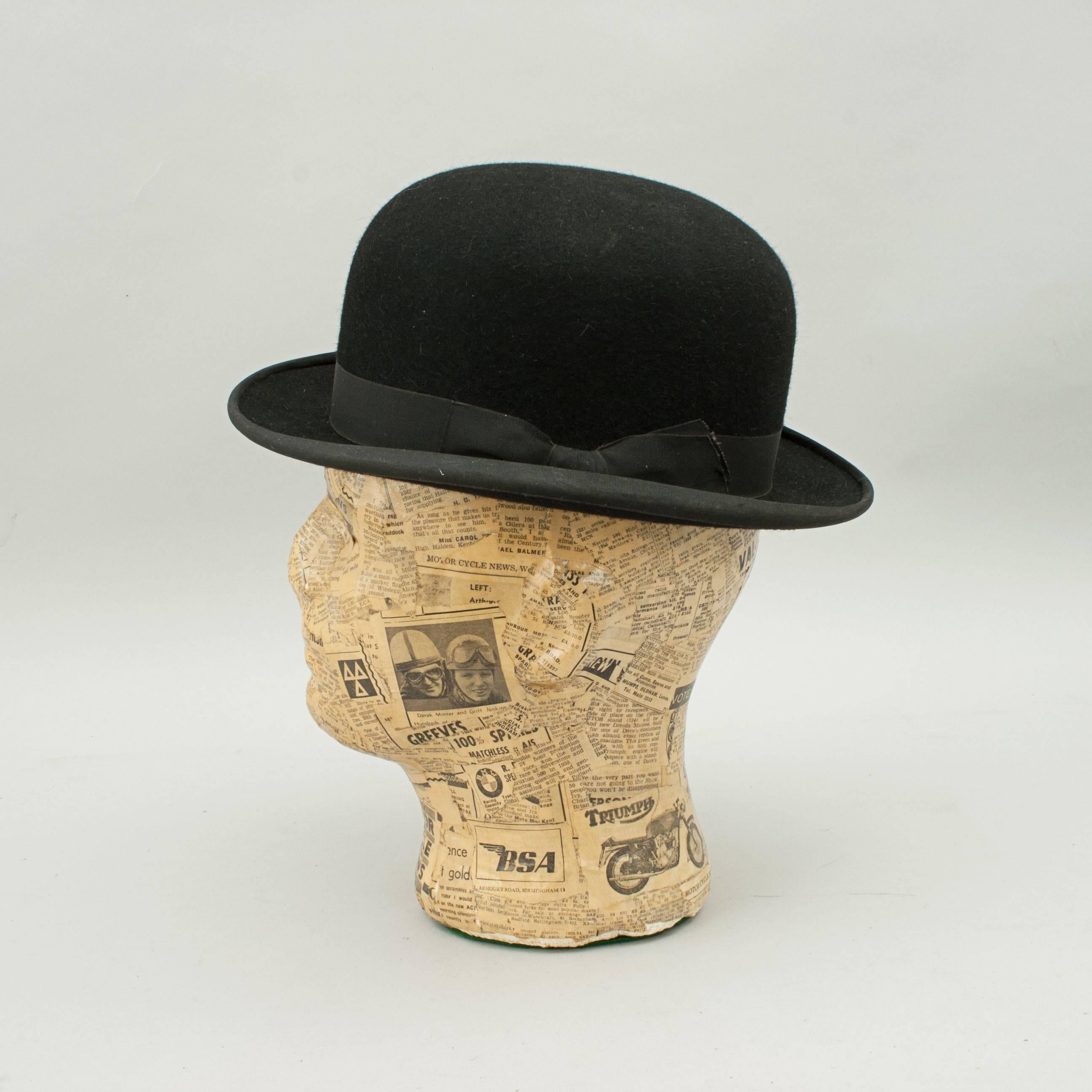 Equestrian bowler hat by Herbert Johnson. 
A hard crown black bowler hat with a shaped brim made by Herbert Johnson, New Bond Street. The black felt hat is lined with white satin with the Herbert Johnson logo and details. The hat is finished with a
