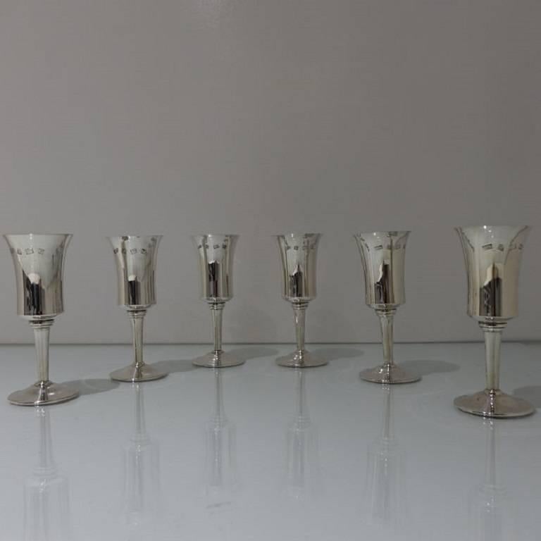 A set of six elegantly crafted plain formed champagne flutes with tapering designed bowls which have been gilt on the inside.