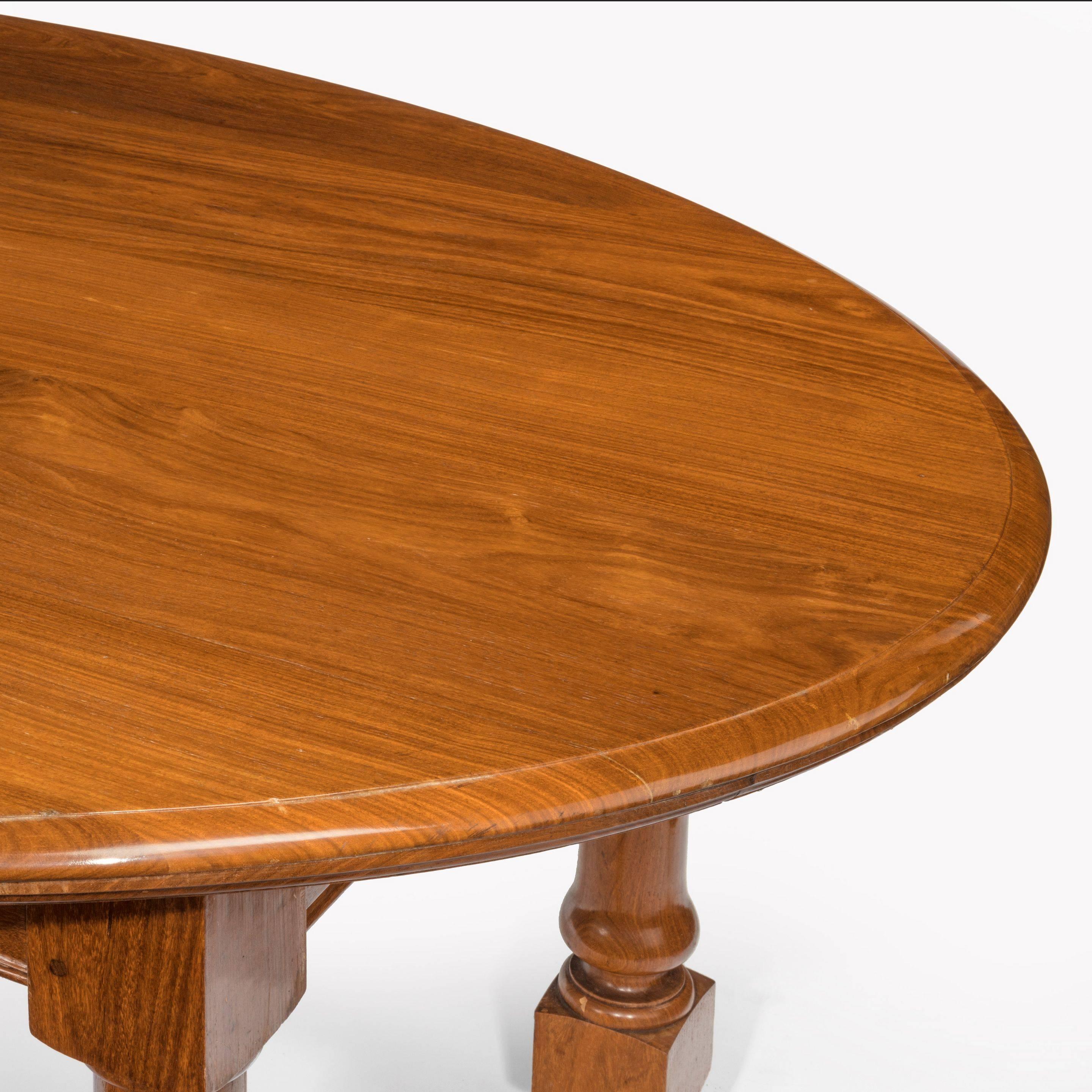 An extremely Rare oval 19th century colonial hardwood campaign table. The large oval top is detachable from the folding gun barrelled turned legs. Circa 1860 