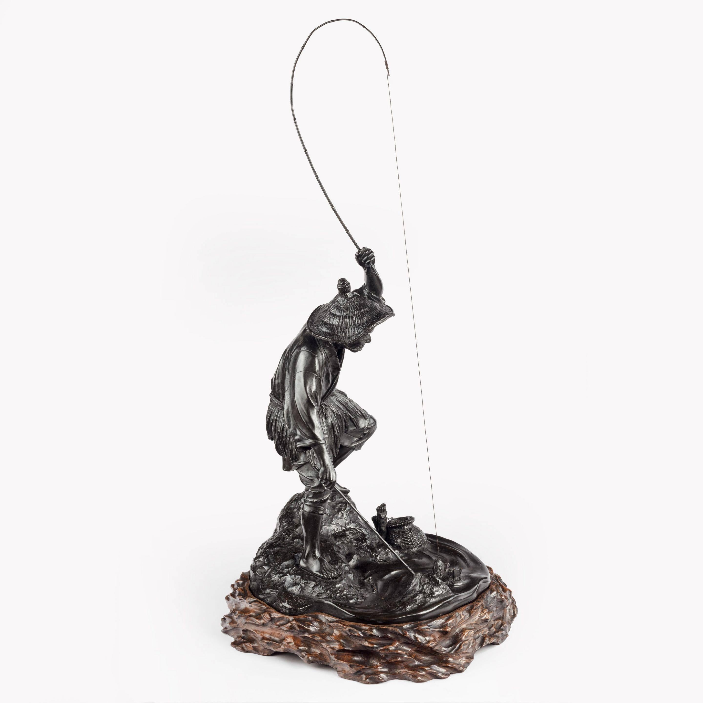 A dynamic Tokyo school bronze of a fisherman by Jonan, wearing a straw hat and rush apron he holds the rod and hooked fish in his left hand as he prepares to land the fish in his net, signed Jonan saku 城南作. Japanese, c1890. 

The quality and