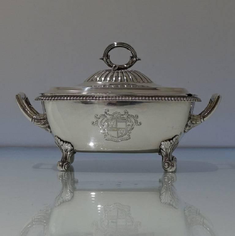 A very beautiful and extremely fine pair of gadroon border oblong sauce tureens with detachable partial fluted lids. The tureens stand on four stylish feet and are far superior to any other boxed tureens we have handled. There is a stunning