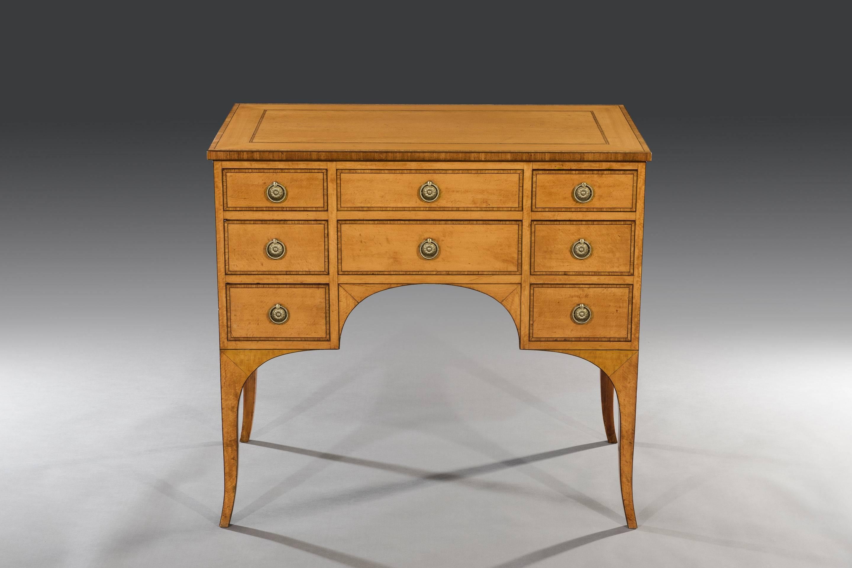 The inlaid rectangular top lifts up to reveal a dressing mirror and two compartments above two short and one long faux drawer. The four short and one long drawers arranged below are full length and mahogany lined. The drawers are fitted with the