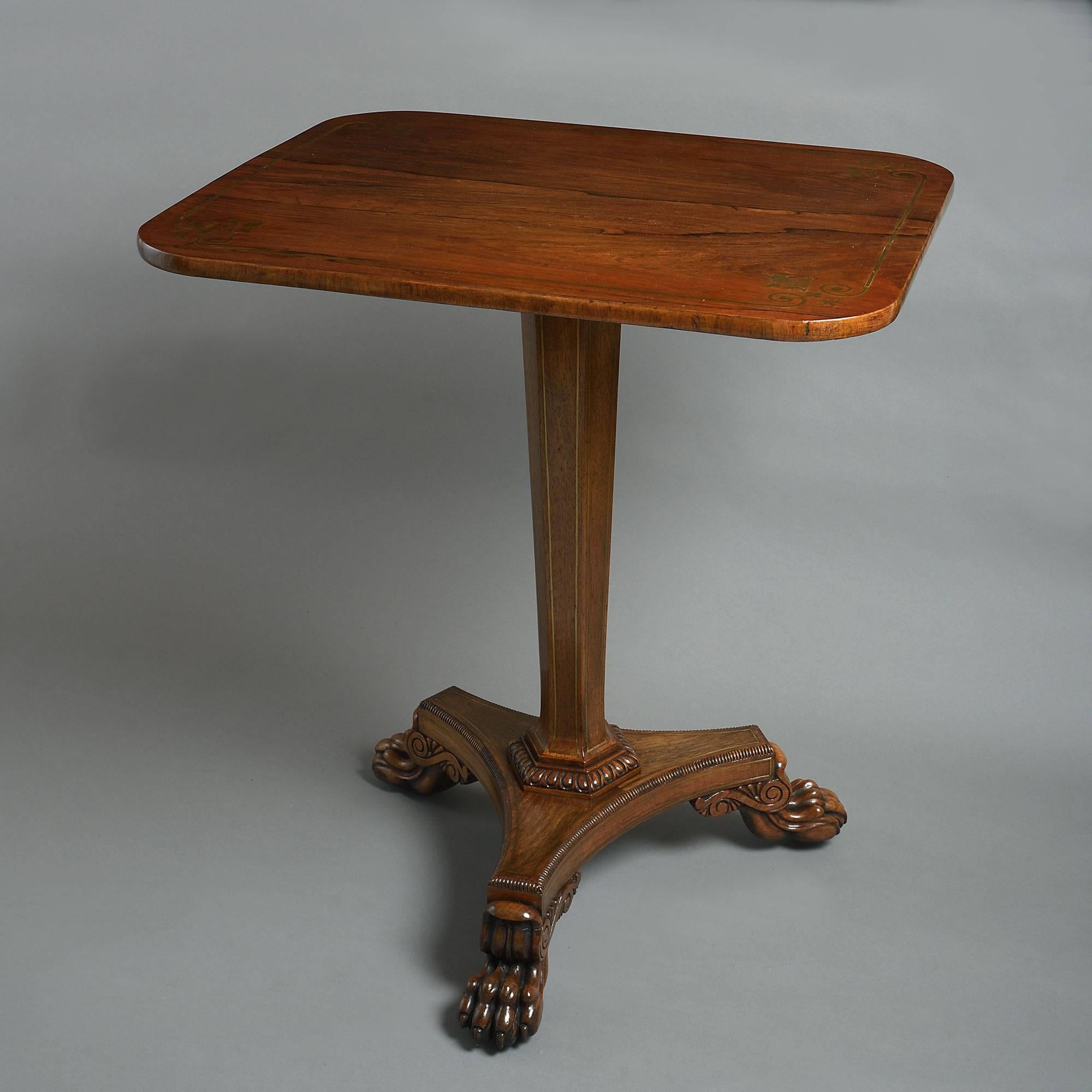 An early 19th century Regency period finely figured rosewood centre table, the rectangular top with brass inlay, the tapering hexagonal stem with brass stringing and egg and dart moulded base, supported upon a gadrooned concave tri-form plinth,