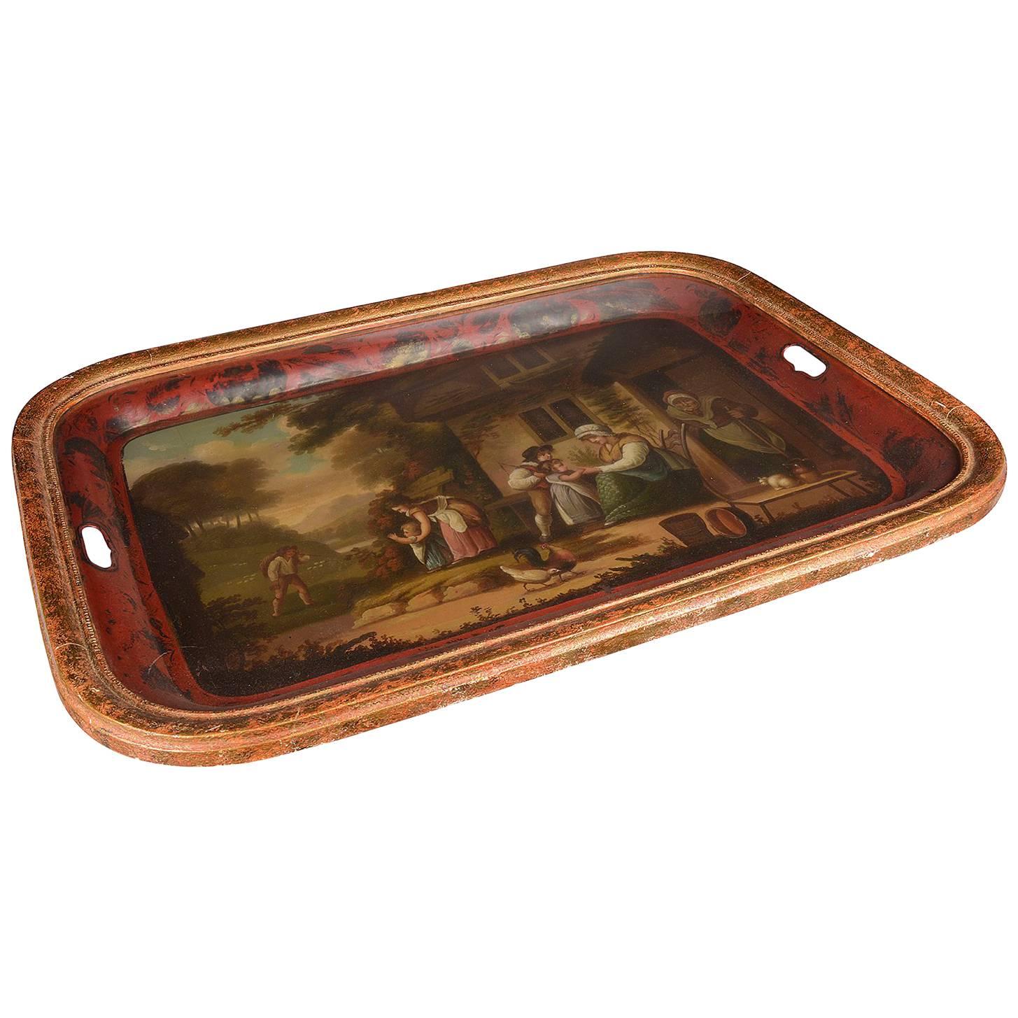 A very pleasing 19th century English red painted tole tray, having a rural family scene out side an old farm house painted to the centre, a red boarder and set in a gilded frame with glass to protect it.
We can have faux bamboo bases made to turn