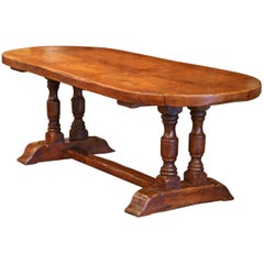 Mid-20th Century French Oval Chestnut and Oak Rustic Trestle Farm Table