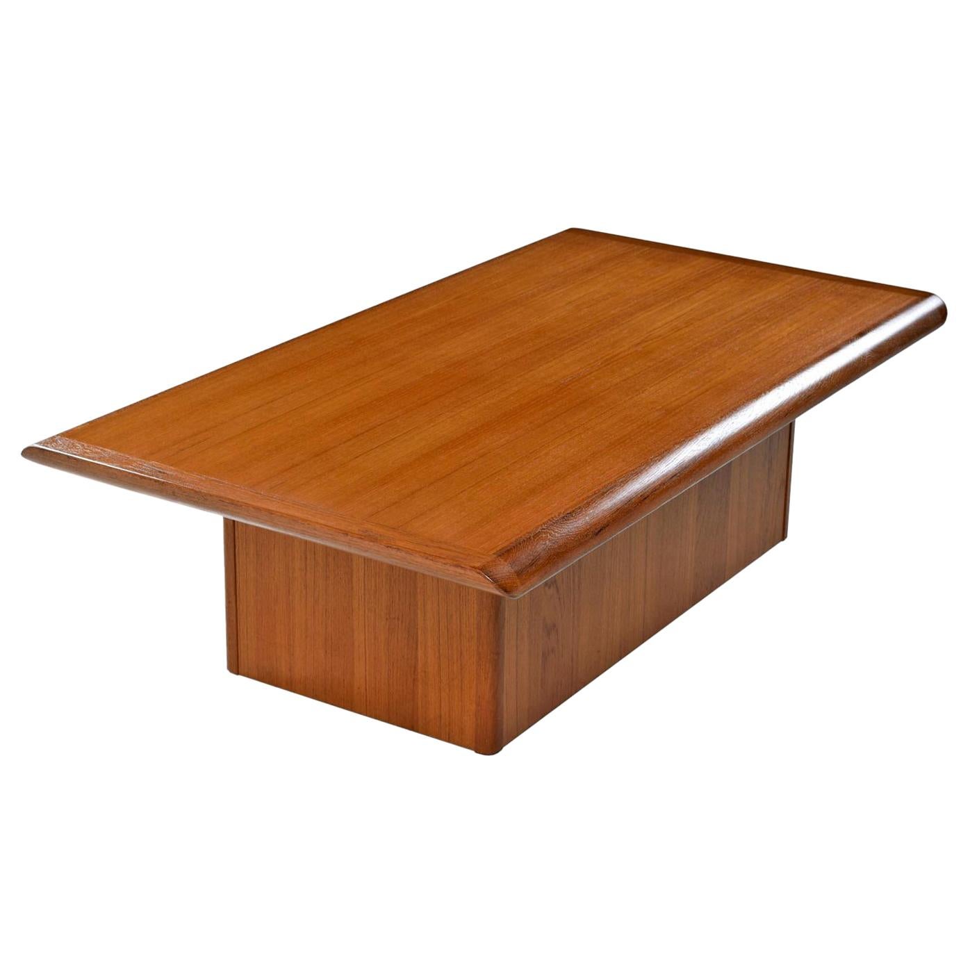 This piece of Danish artistry firmly hold its own as it stands on a monumental pedestal base. Rich, dark amber patina and stunning cathedral grain teak. Made by Vejle Stole & Møbelfabrik. The teak tabletop has been professionally refinished by our