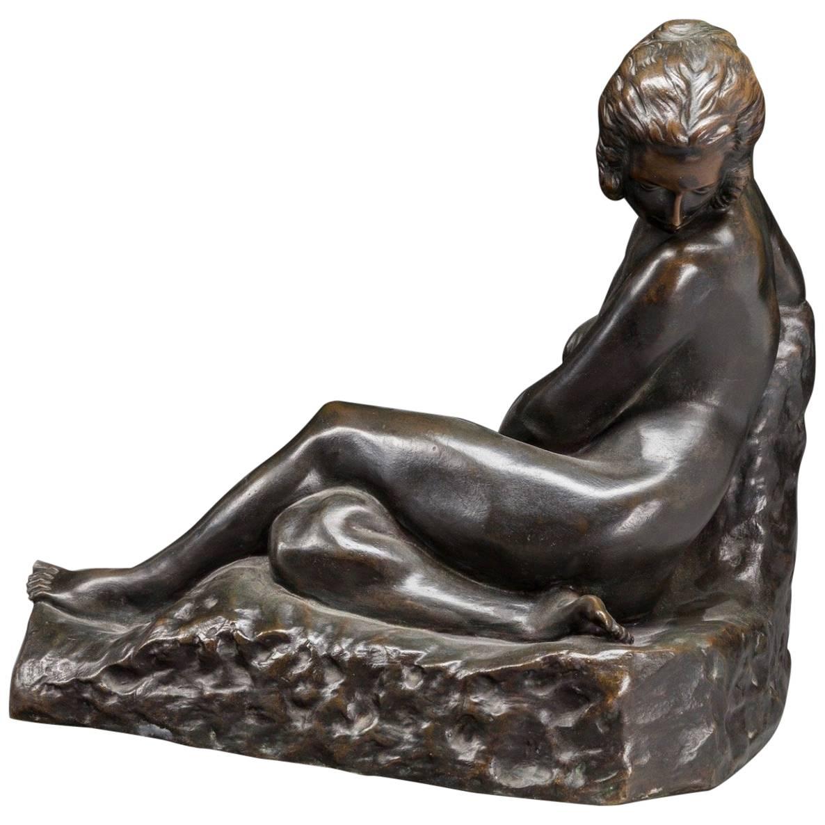 Antoine Bouraine bronze representing a reclining beautiful nude figure of a lady with her head turned away. Bronze with a rich dark brown to black patina. A very moving art piece that will place well in an Art Deco to art nouveau environment. A very