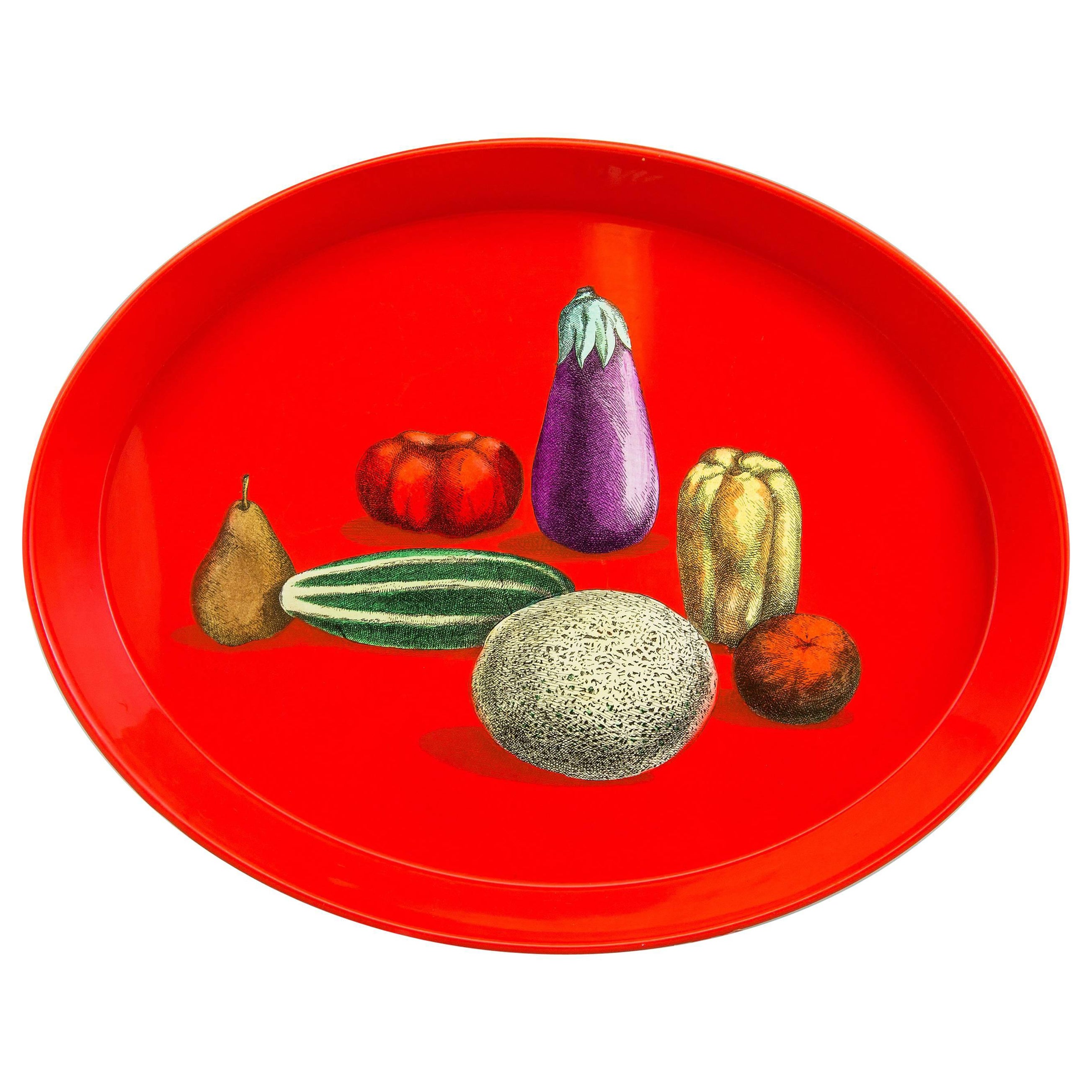 This is how you serve your guests in style!

A Piero Fornasetti tray with still life, Natura Morta pattern, Mid- 1950s.

This is a wonderful early 1950s oval red tray depicting various vegetables in a still life composition in excellent