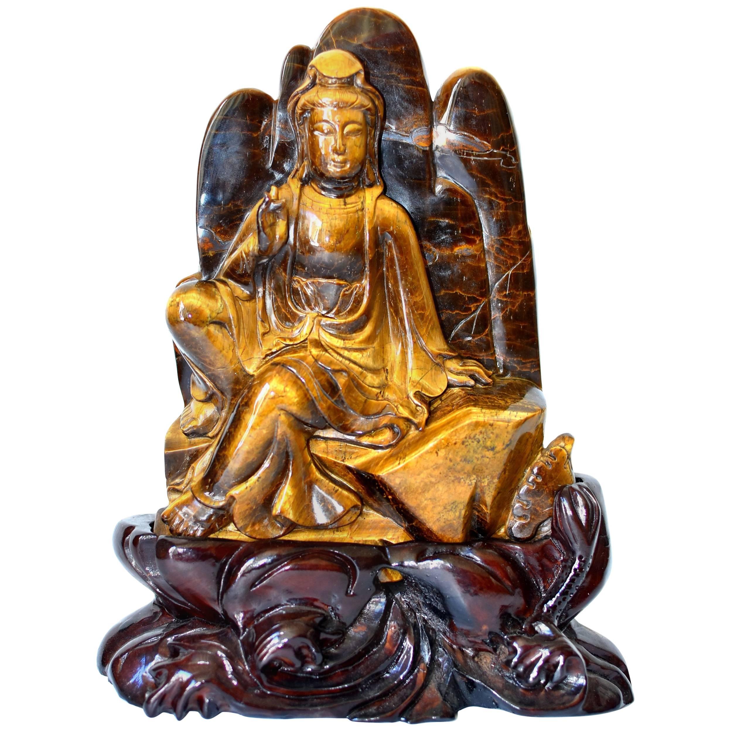 A beautiful natural tiger's eye sculpture depicting Kwan Yin, the Goddess of Great Compression. This entire sculpture is made of one piece of the natural tiger's eye. This piece is of the finest quality with fantastic iridescence. Kwan Yin's facial