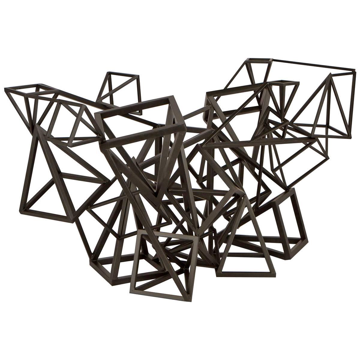 Incredible table in metal. Table was produced as a display piece for a store in Beverly Hills in the 1970s. Table is comprised of a myriad of geometric shapes fabricated together and can be used as either a dining table base or a console table.