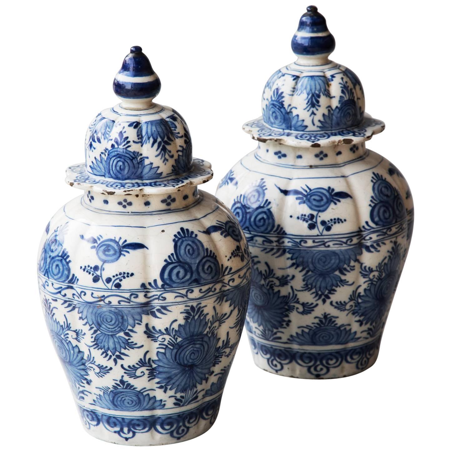 Pair of 18th Century Blue and White Faience Baluster Vases with Shaped Lids For Sale
