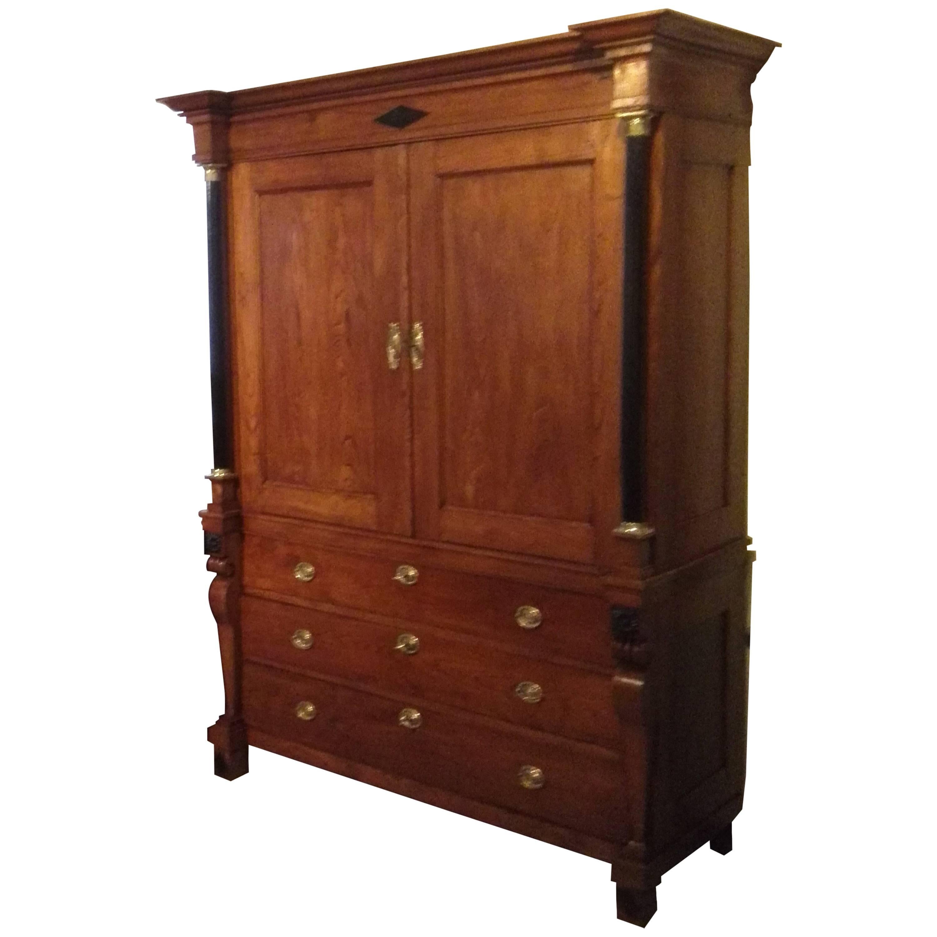 Great linen-press in perfect restored condition! Solid ashwood with ebonized full columns! With original pedestals and capitals in polished gold brass! The application in ebonized, polished wood. All fittings and box locks are original and