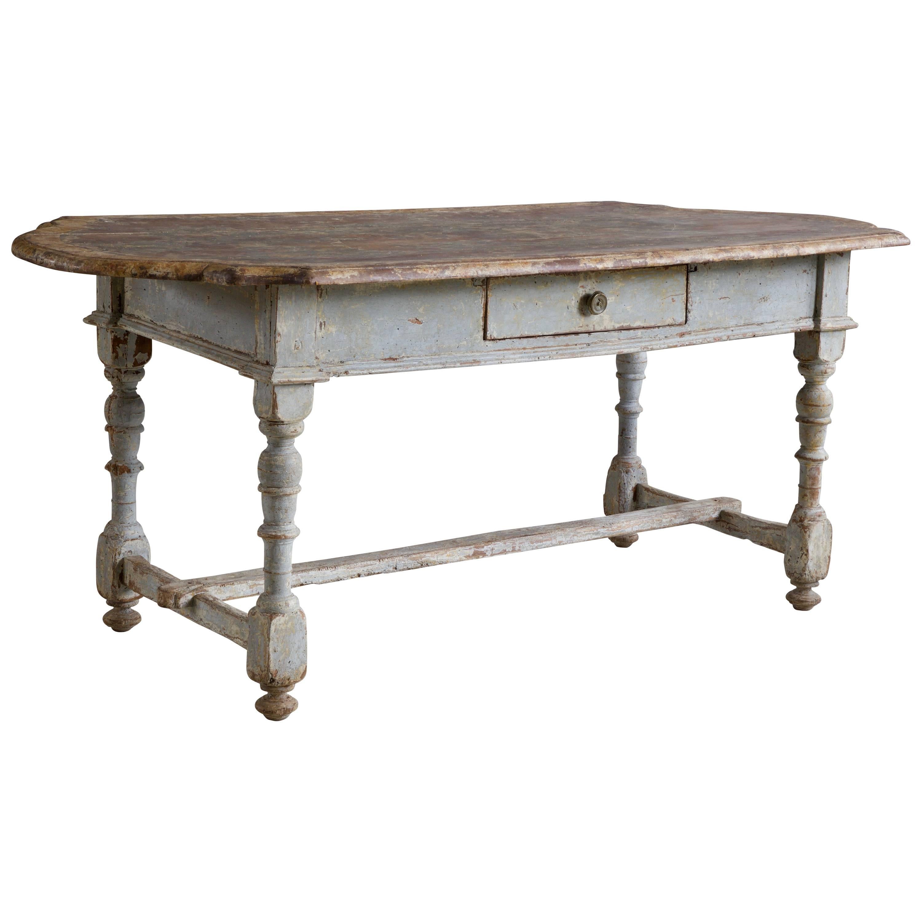 17th century rustic farmhouse table from the East coast of Italy made in solid walnut with a distinctively shaped table top and turned legs. The table has a drawer under the table top with the original handle pull. The table has retained its