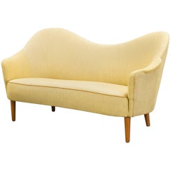 Carl Malmsten curved yellow Samspel sofa / loveseat, mid 20th Century, Sweden.