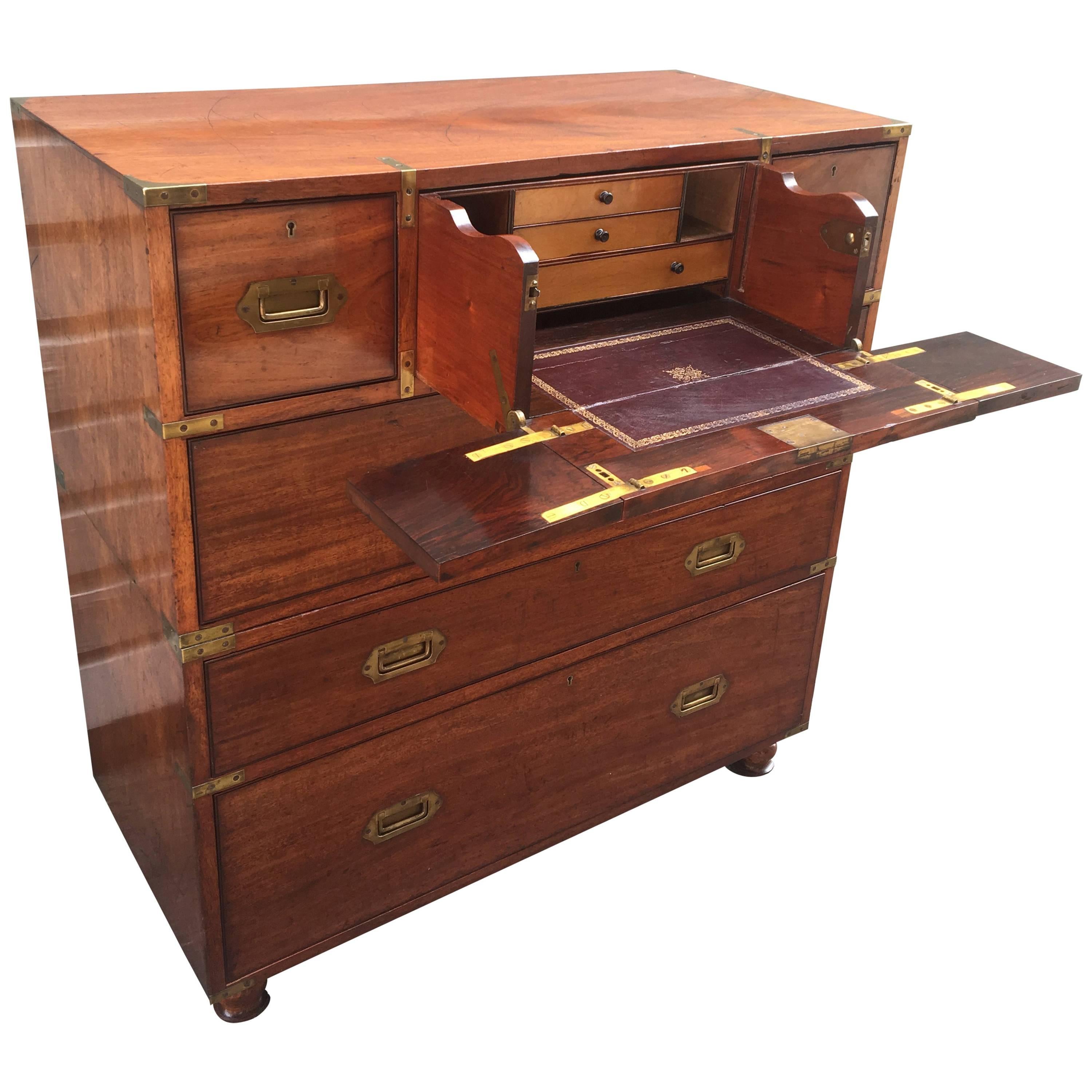 This mid-19th century brass-mounted mahogany two-part Campaign chest has a removable mahogany panel covering the satinwood. Fitted interior of the secrétaire drawer with usual folding sides. Beautiful screw on removable feet. Rare candlestick