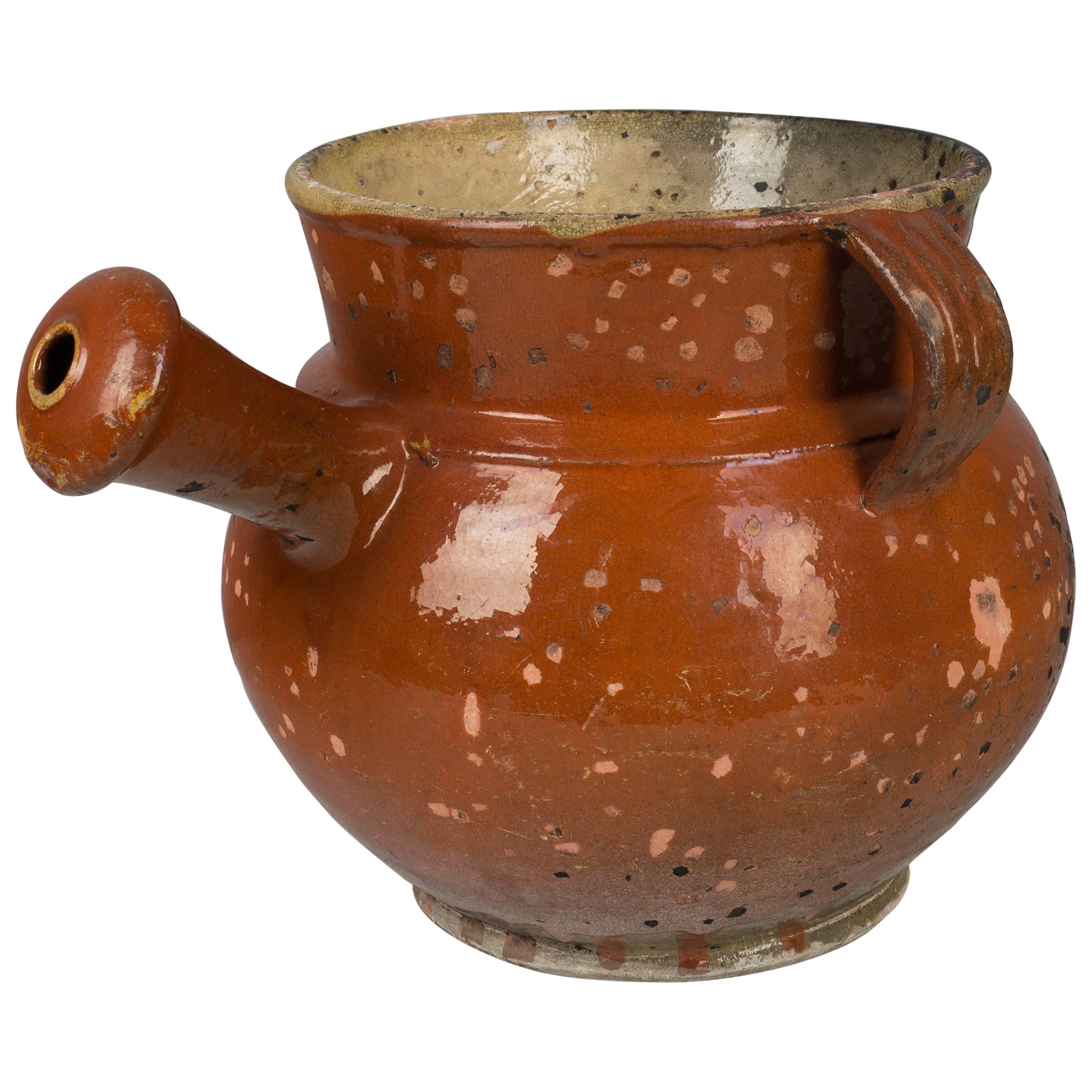 A 19th century, French glazed terracotta pot with two small handles on either side and a large handle that looks like a spout. Beautiful color and patina. Please refer to photos for more details.  Please refer to photos for more details. Pictures