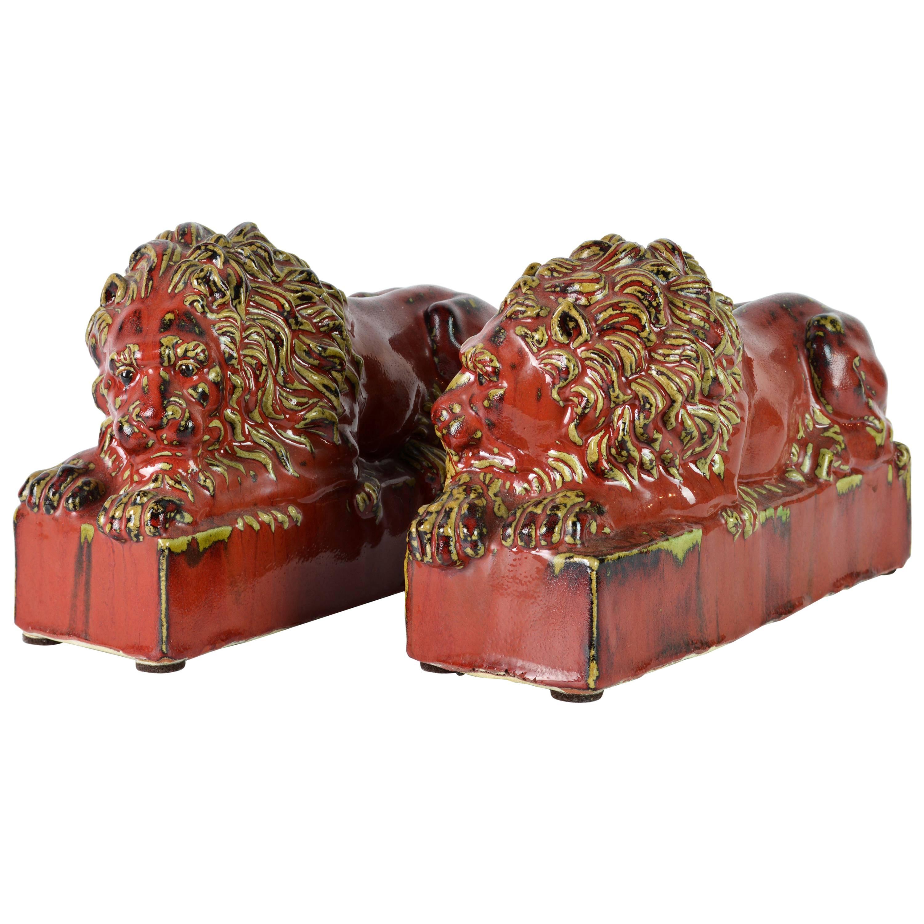Opposing Pair of 20th Century Oxblood and Celadon Glazed Ceramic Resting Lions