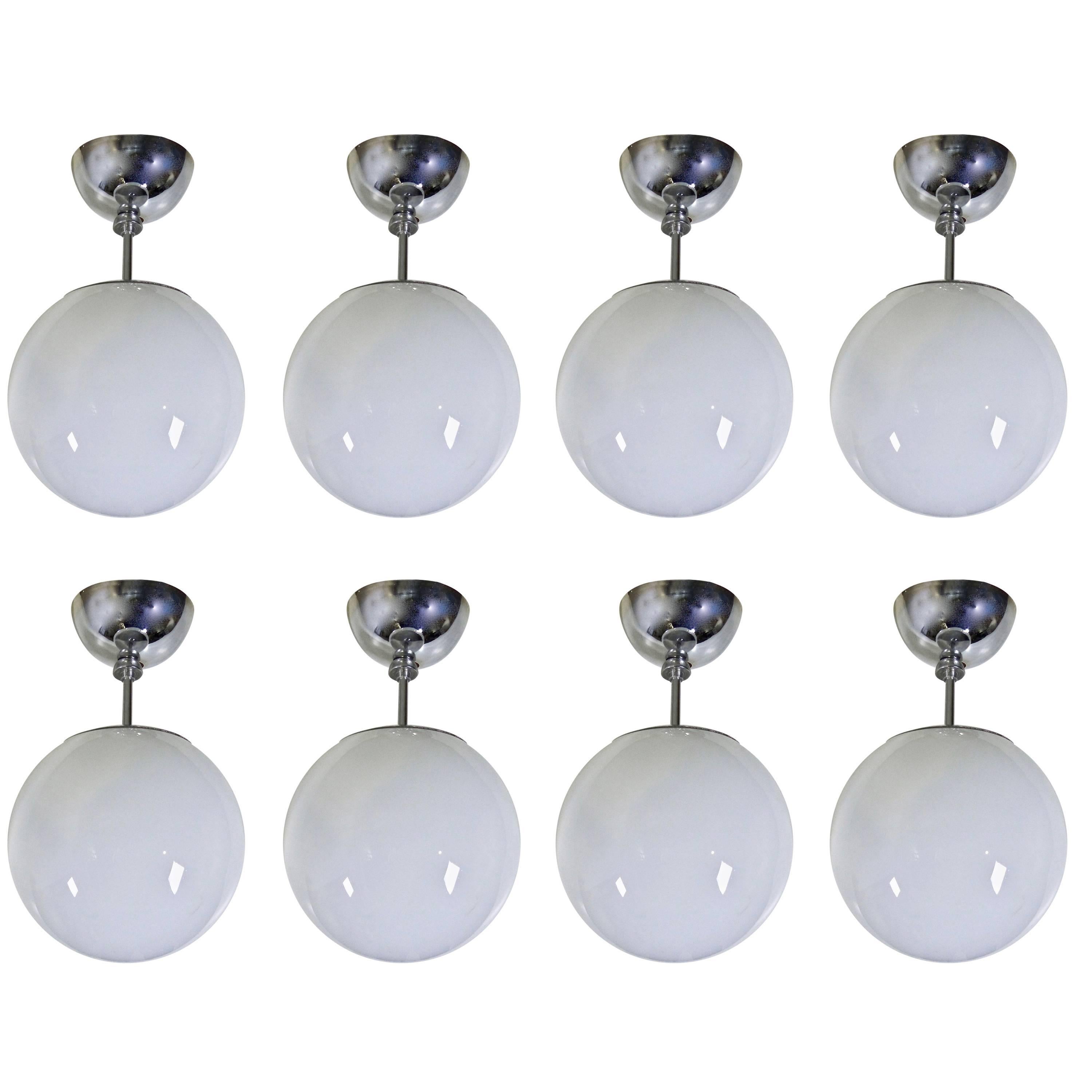 Set of four Mid Century Pendant Fixtures with Spherical Milk Glass Globes